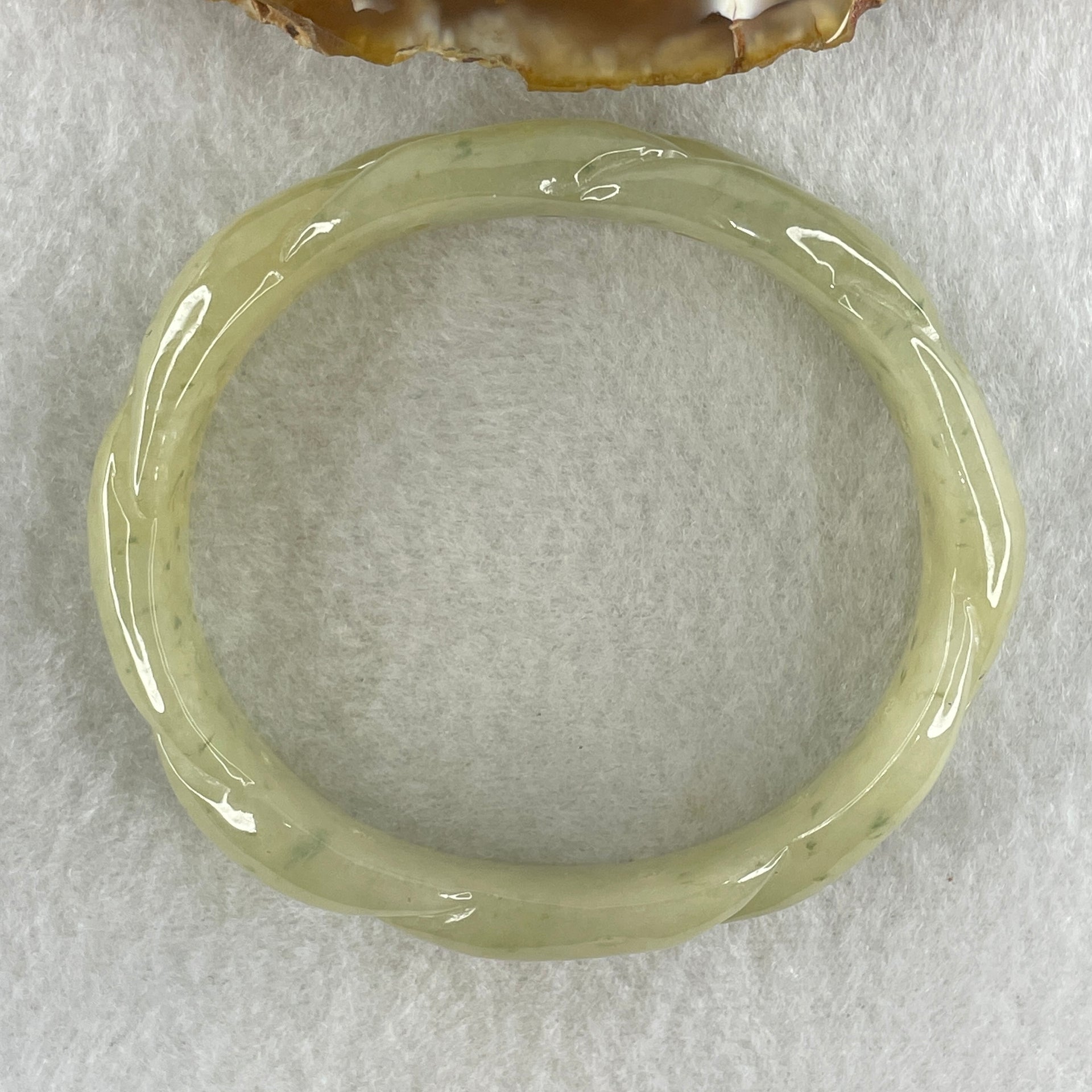 Type A Natural Yellowish Green Jadeite Oval Carved Bangle 41.73g Inner Diameter 54.2mm 16.5 by 7.1mm (Very Very Slight Internal Lines) - Huangs Jadeite and Jewelry Pte Ltd