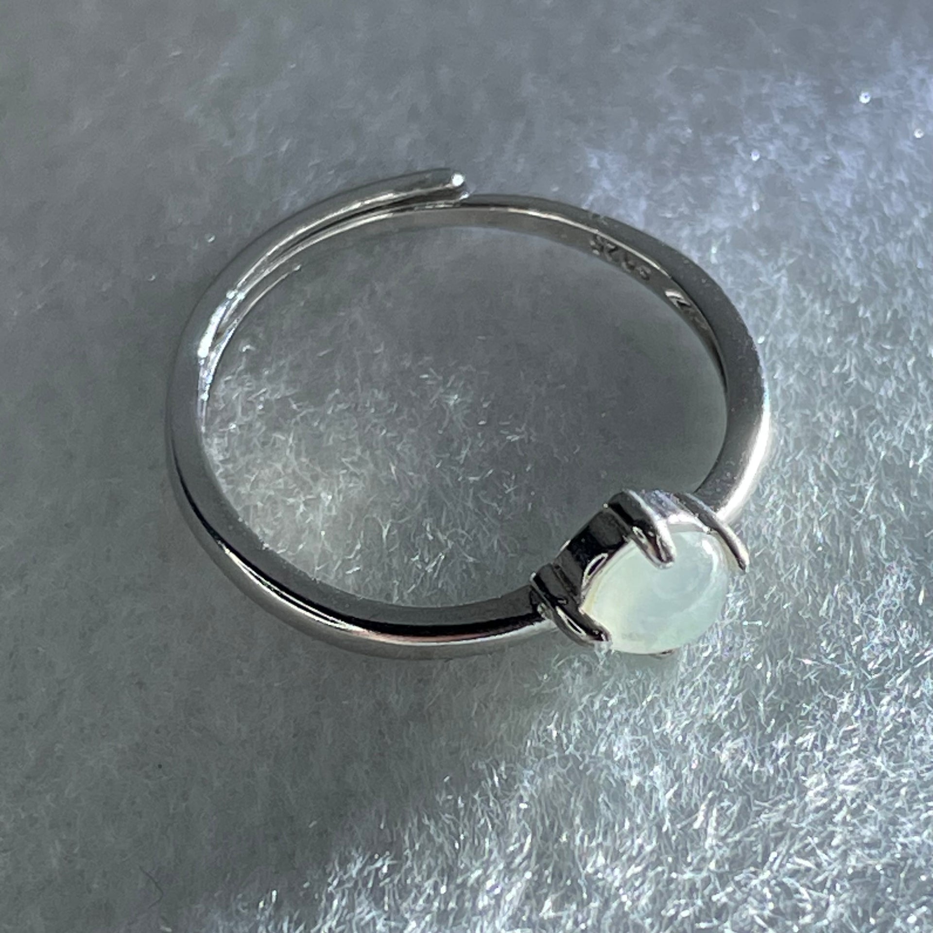 Type A Icy Faint Green Cabochon Jadeite in S925 Sliver Ring (Adjustable Size) 1.05g 4.5 by 3.0mm - Huangs Jadeite and Jewelry Pte Ltd