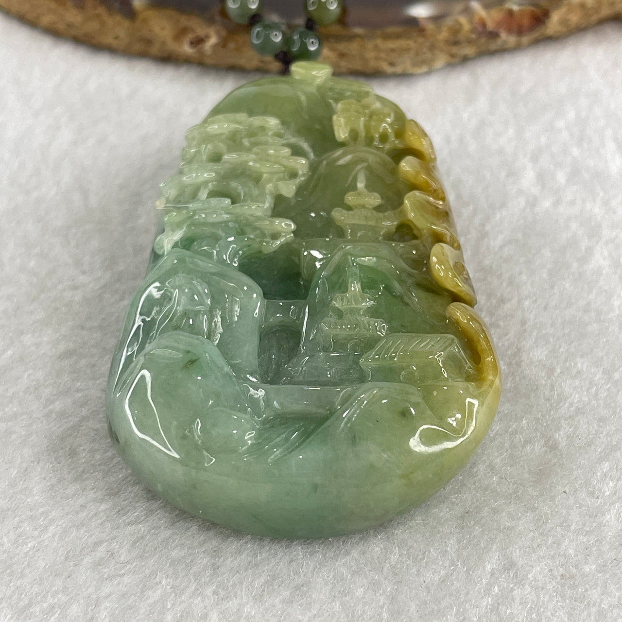 Natural Type A Green with Yellowish Jadeite Shan Shui with Gui Ren Pendant 127.68g 75.0 by 44.7 by 14.7mm - Huangs Jadeite and Jewelry Pte Ltd