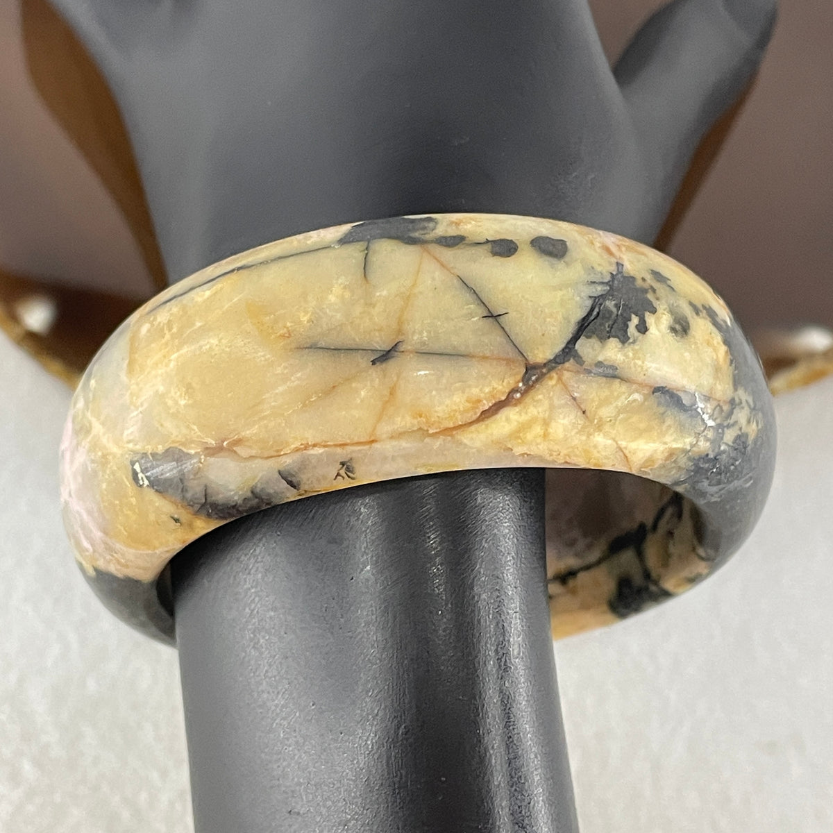 Entry Grade Natural Yellow with Black Rhodonite Bangle 105.93g Inner Diameter 55.2mm 25.5 by 11.7mm - Huangs Jadeite and Jewelry Pte Ltd