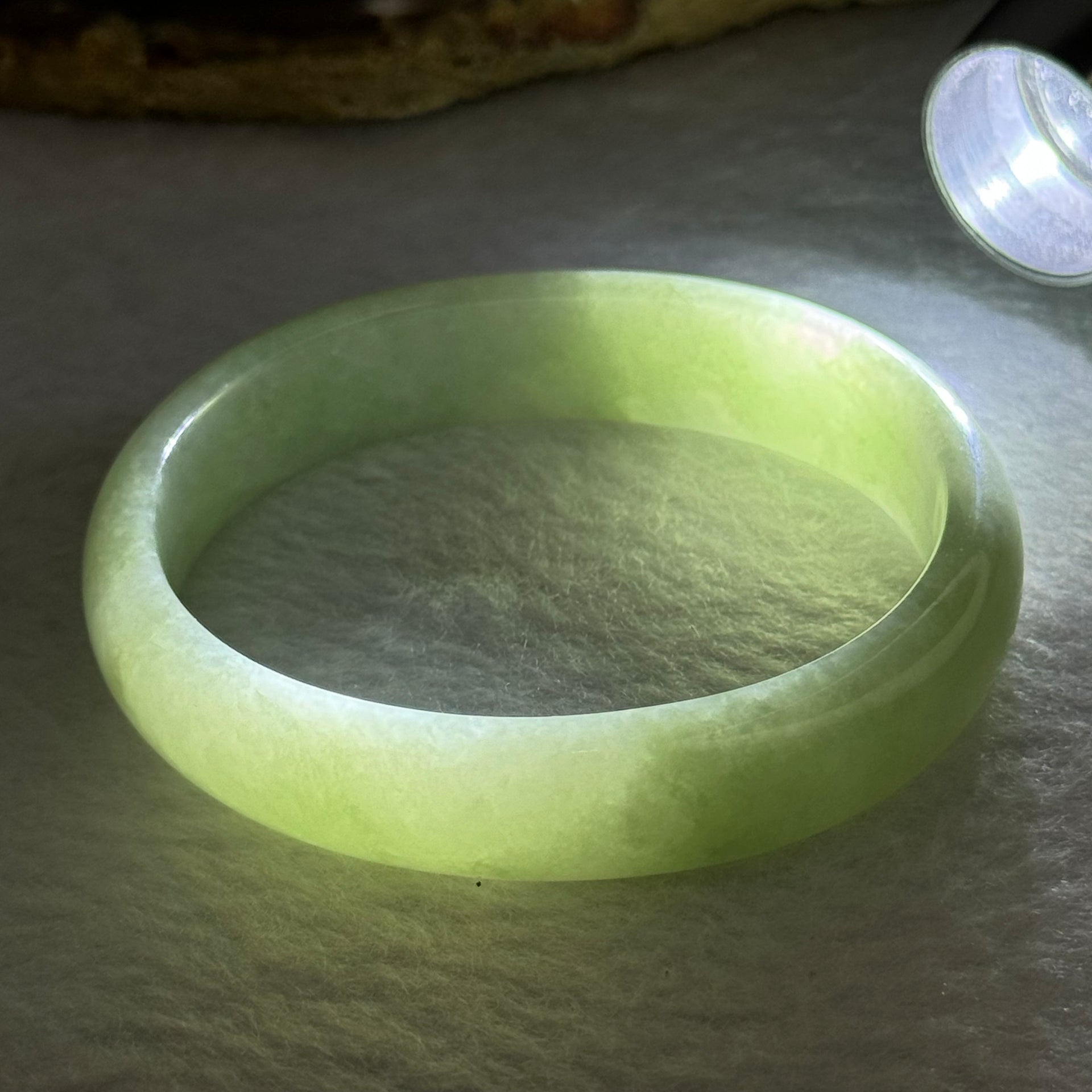 Type A Light Apple Green Jadeite Oval Bangle 33.35g Internal Diameter 52.3mm 12.2 by 6.5mm (Very Slight Fine Internal Lines) - Huangs Jadeite and Jewelry Pte Ltd