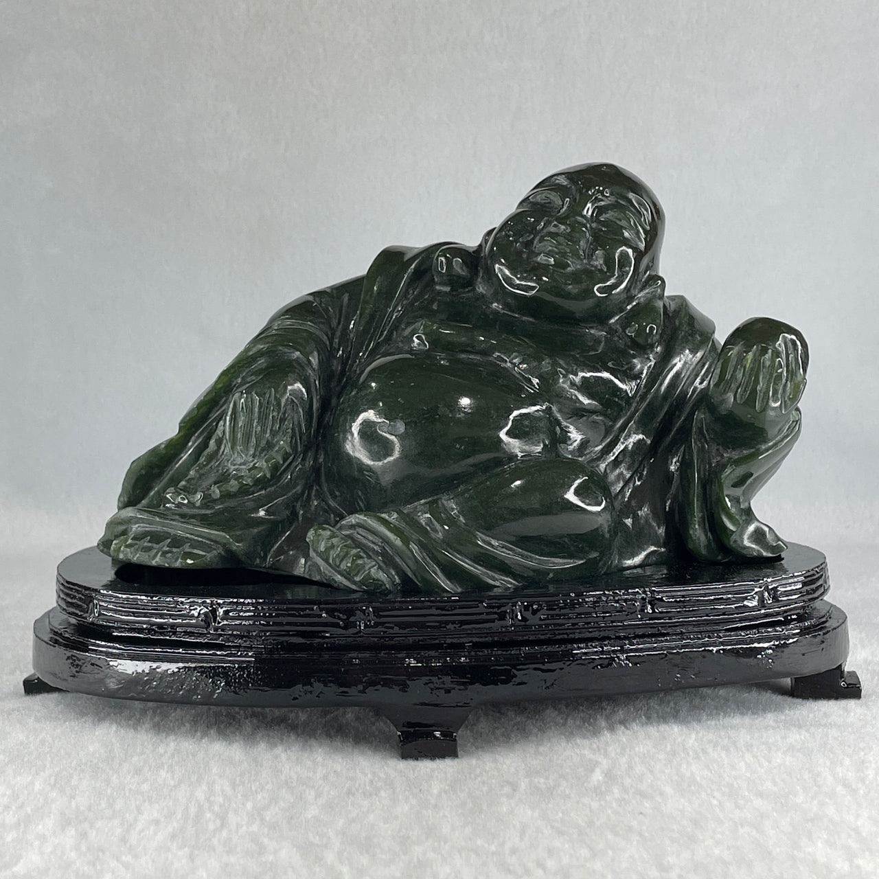 Natural Dark Green Serpentine Laughing Milo Buddha with Wealth Pot with Wooden Stand Display 1,656.6g 190.0 by 133.0 by 127.0mm - Huangs Jadeite and Jewelry Pte Ltd