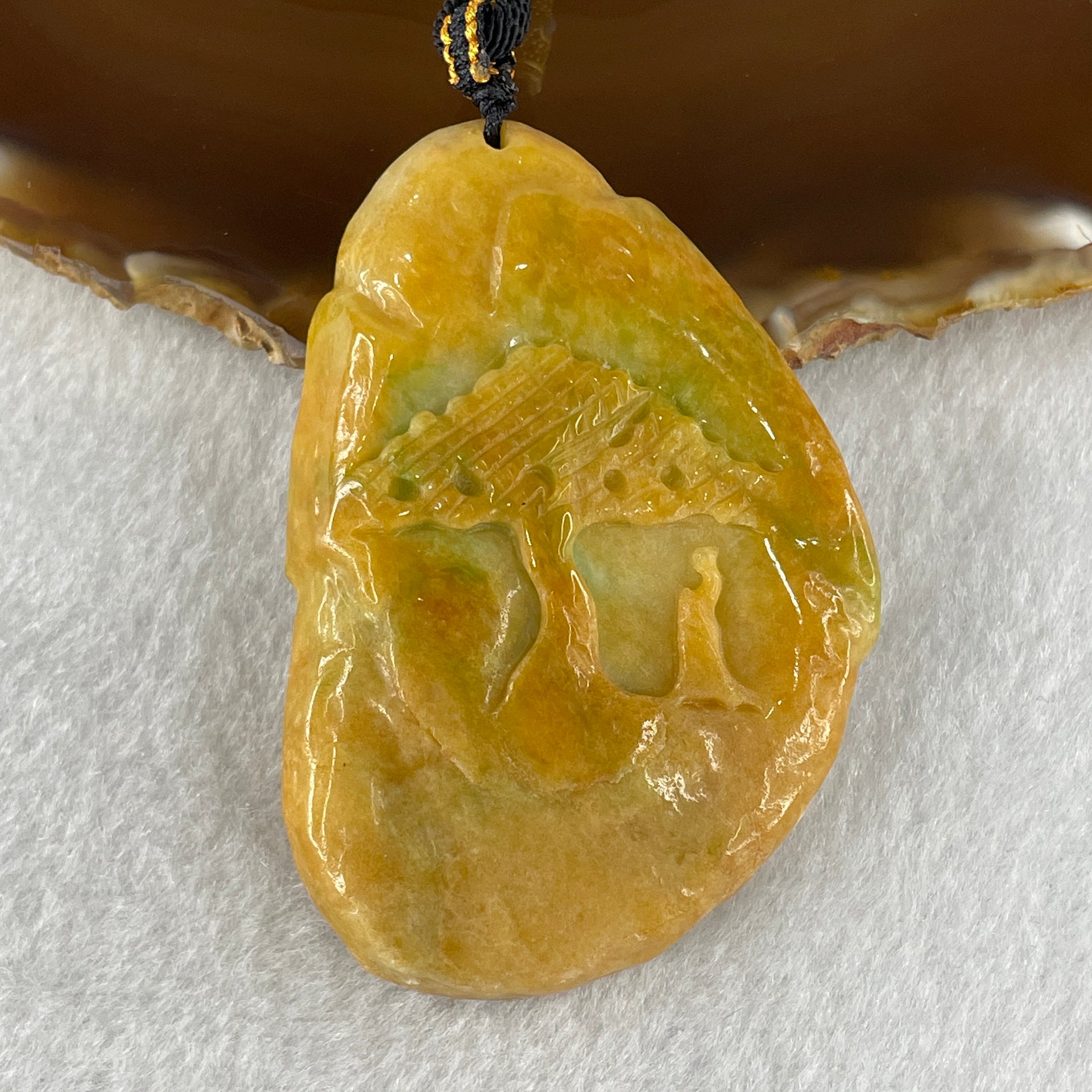 Rectangular translucent yellow jadeite pendant carved with shan shui landscape scene