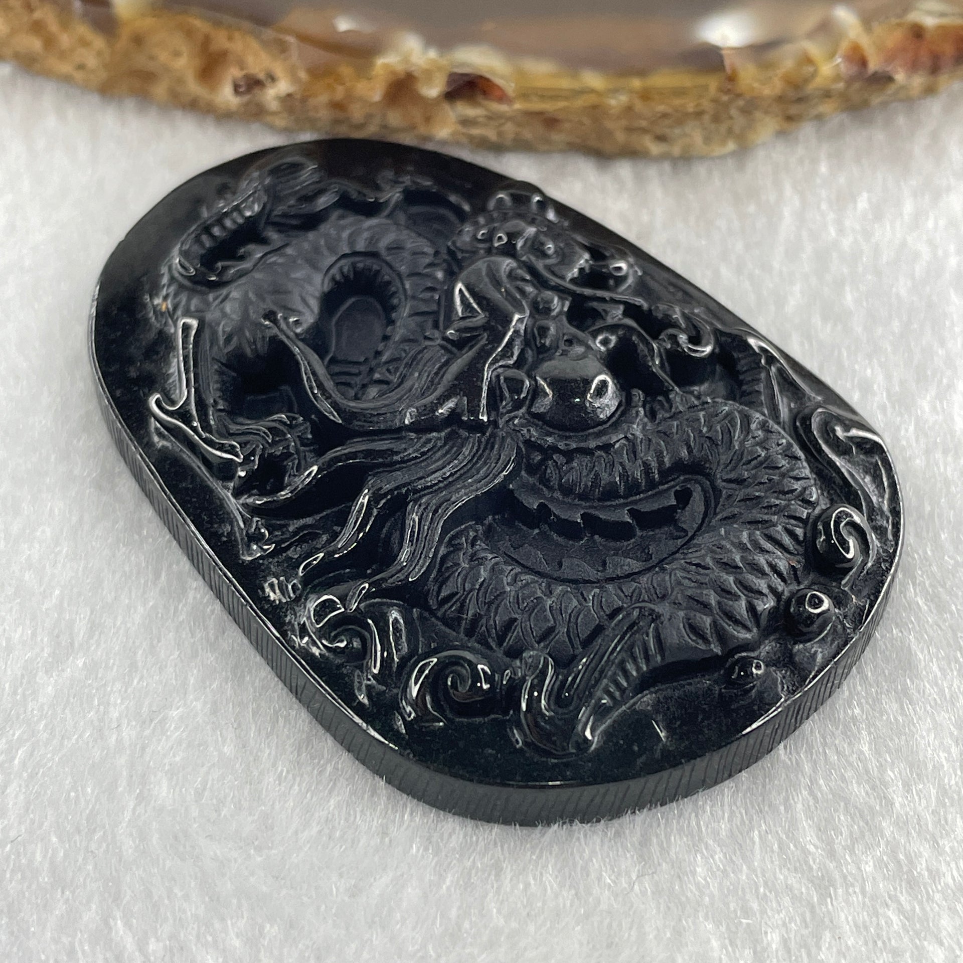 Type A Opaque to Partial Translucent Black Omphacite Jadeite Dragon Pendant 24.58g 58.2 by 40.3 by 8.2mm - Huangs Jadeite and Jewelry Pte Ltd