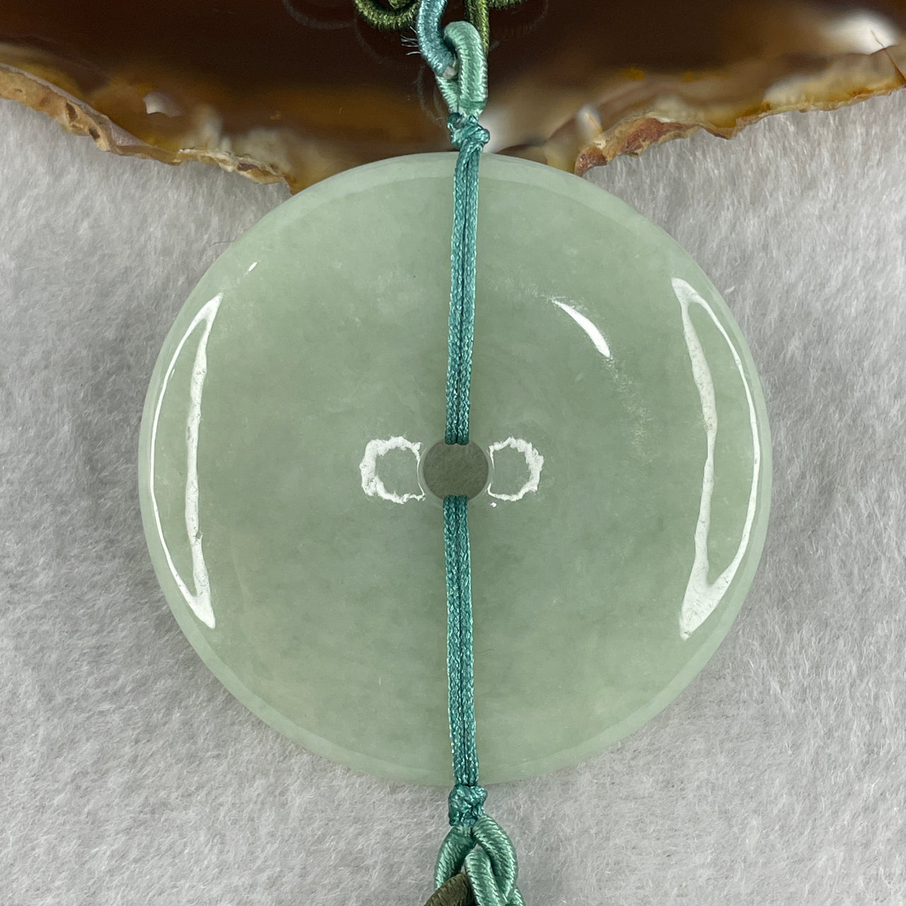 Natural Type A Light Green Jadeite Ping An Kou Donut Pendant in Hanging Display String 57.40g 50.3 by 7.8mm
