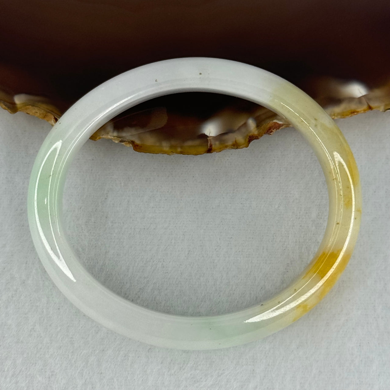 Type A Faint Lavender Green with Yellow Patches Jadeite Oval Bangle Internal Diameter 56.5mm  37.8696g 11.1 by 7.3mm (Very Slight Internal Line) - Huangs Jadeite and Jewelry Pte Ltd