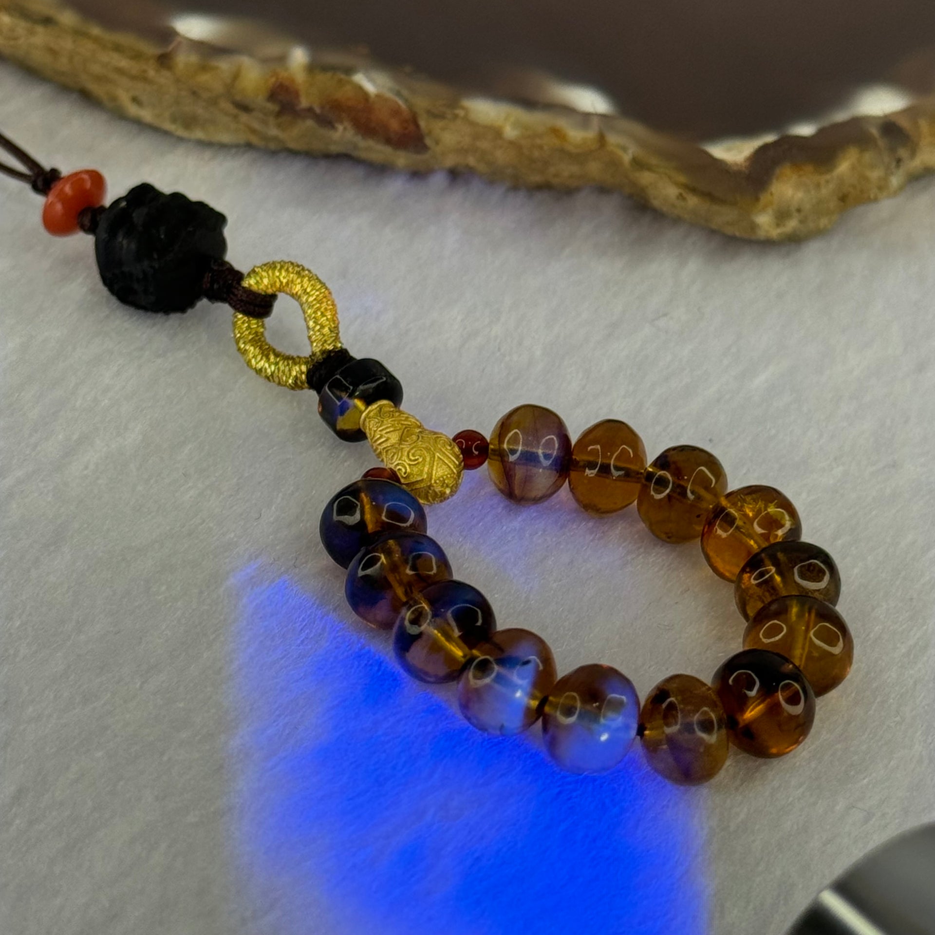 Natural Cognac Amber with Damo Head Handphone Strap 4.30g 7.6mm 13 Beads - Huangs Jadeite and Jewelry Pte Ltd