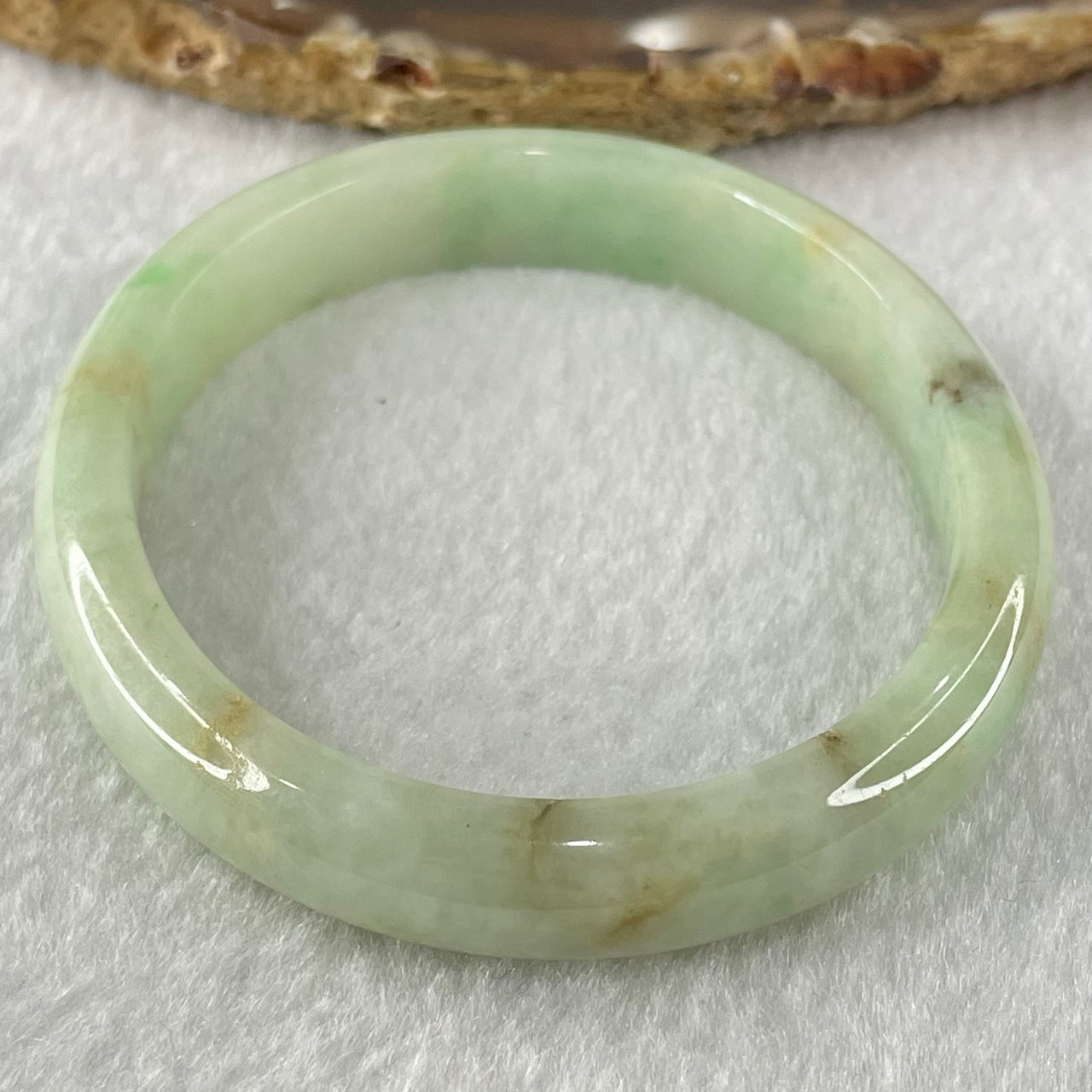 Type A Green with Brown Patches Jadeite Oval Bangle 31.51g Internal Diameter 55.6mm 10.3 by 6.6mm (External Roughs and Internal Lines) - Huangs Jadeite and Jewelry Pte Ltd