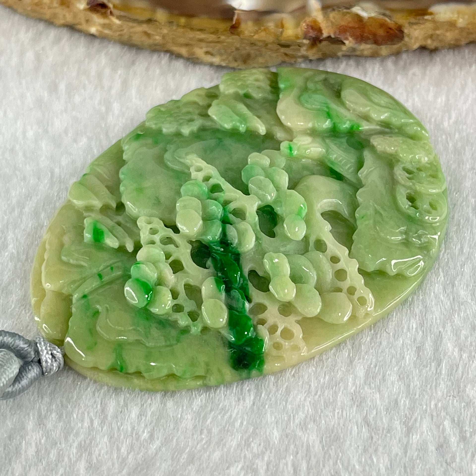Type A Green with Yellow Spicy Green Piao Hua and Light Brown Patches Jadeite Double Sided Shan Shui with Gui Ren Benefactor Pendant 30.43g 54.0 by 40.8 by 8.4mm - Huangs Jadeite and Jewelry Pte Ltd