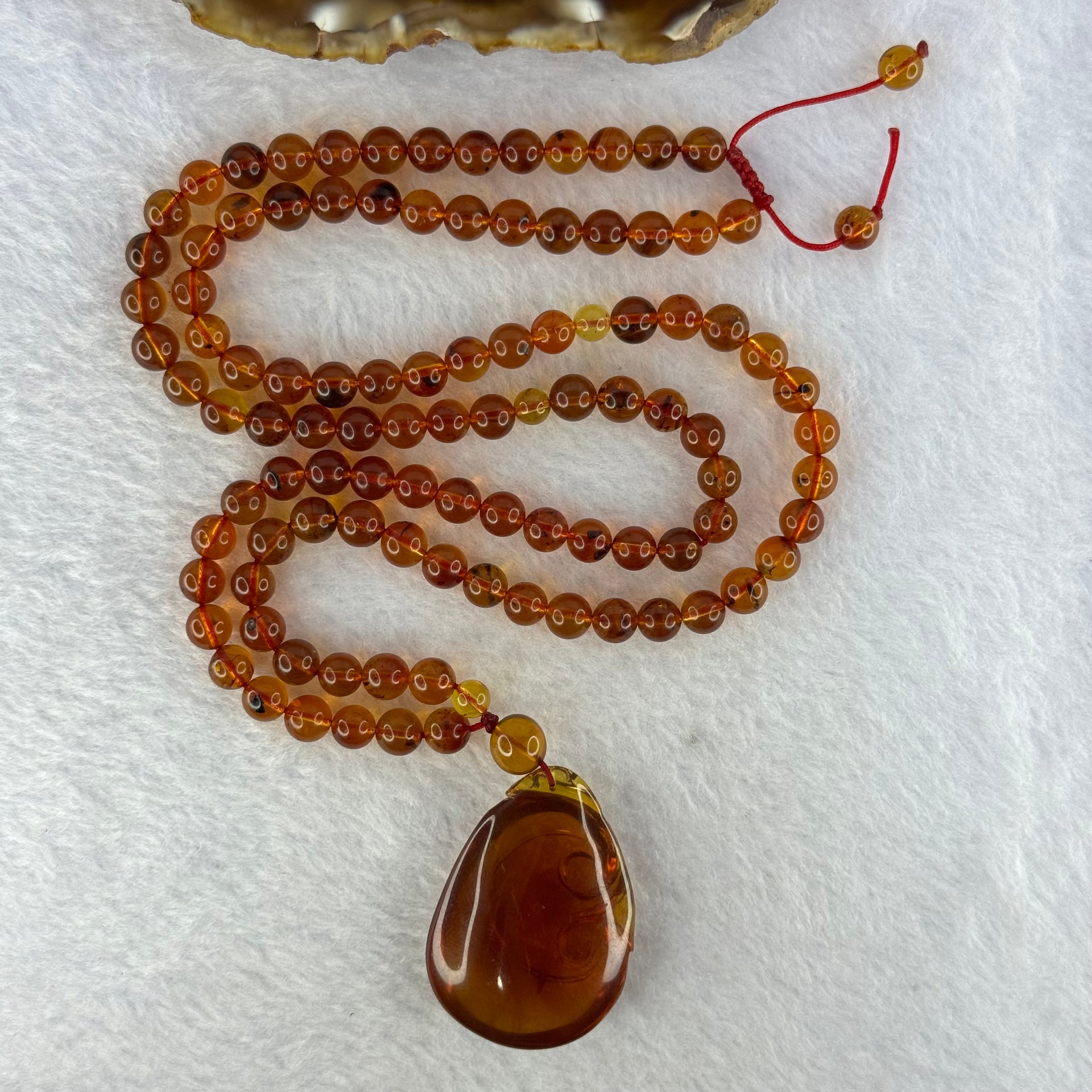 Natural Cognac Amber Ruyi Pendent 37.7 by 27.0 by 12.2mm in Amber Beads Necklace 6.3mm 105 Beads Total 19.80g - Huangs Jadeite and Jewelry Pte Ltd