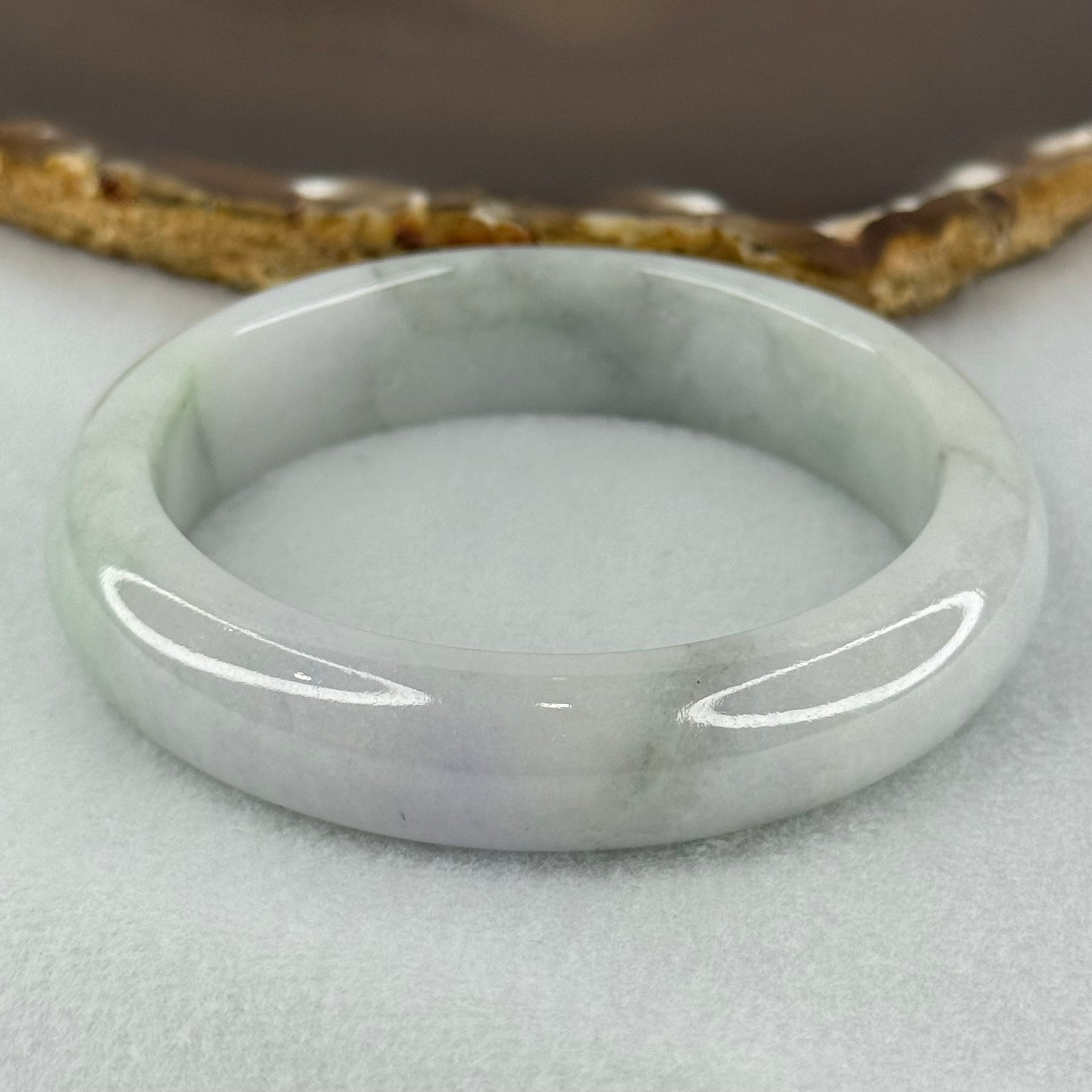 Type A Translucent Faint Blueish Green with Patches of Light Grey and Faint Lavender Jadeite Bangle Internal Diameter 56.95mm 344.09cts 69.22g 14.6 by 8.9mm With NGI Cert No 32886054 (Very Slight Internal Line) - Huangs Jadeite and Jewelry Pte Ltd