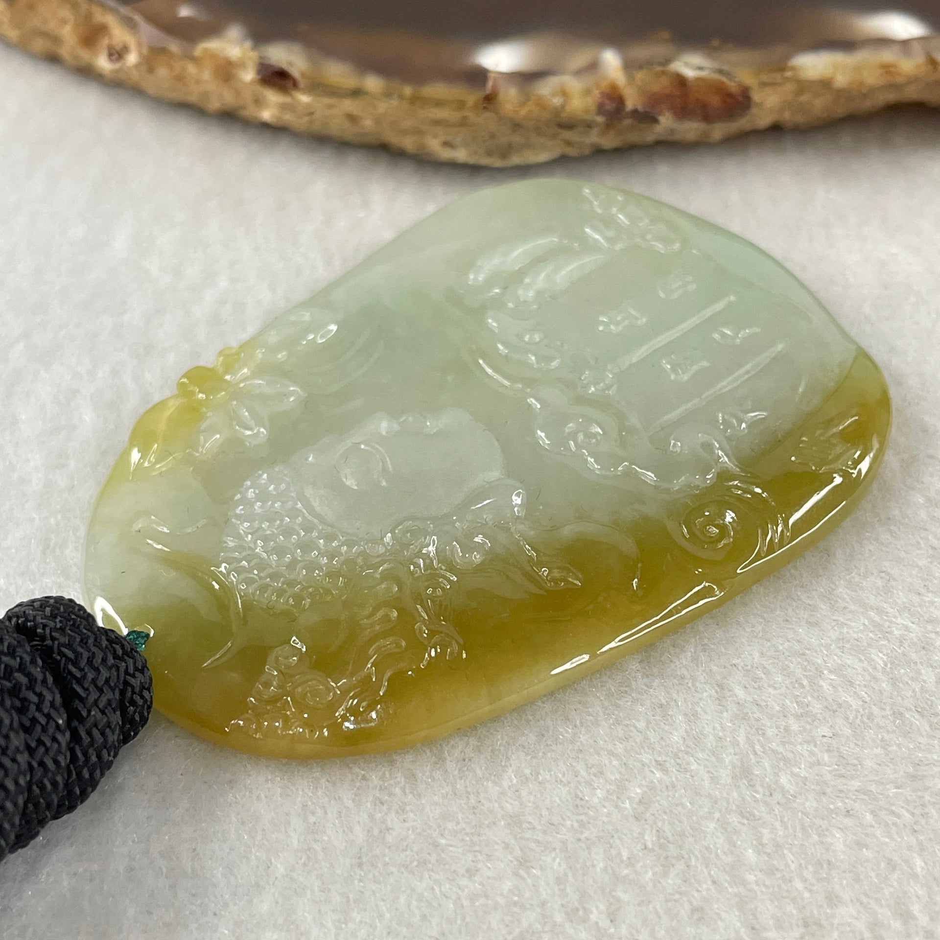 Grand Master Type A Faint Blueish Green with Yellowish Brown Jadeite Good Vs Evil Pendant 22.60g 60.3 by 43.3 by 4.0mm - Huangs Jadeite and Jewelry Pte Ltd