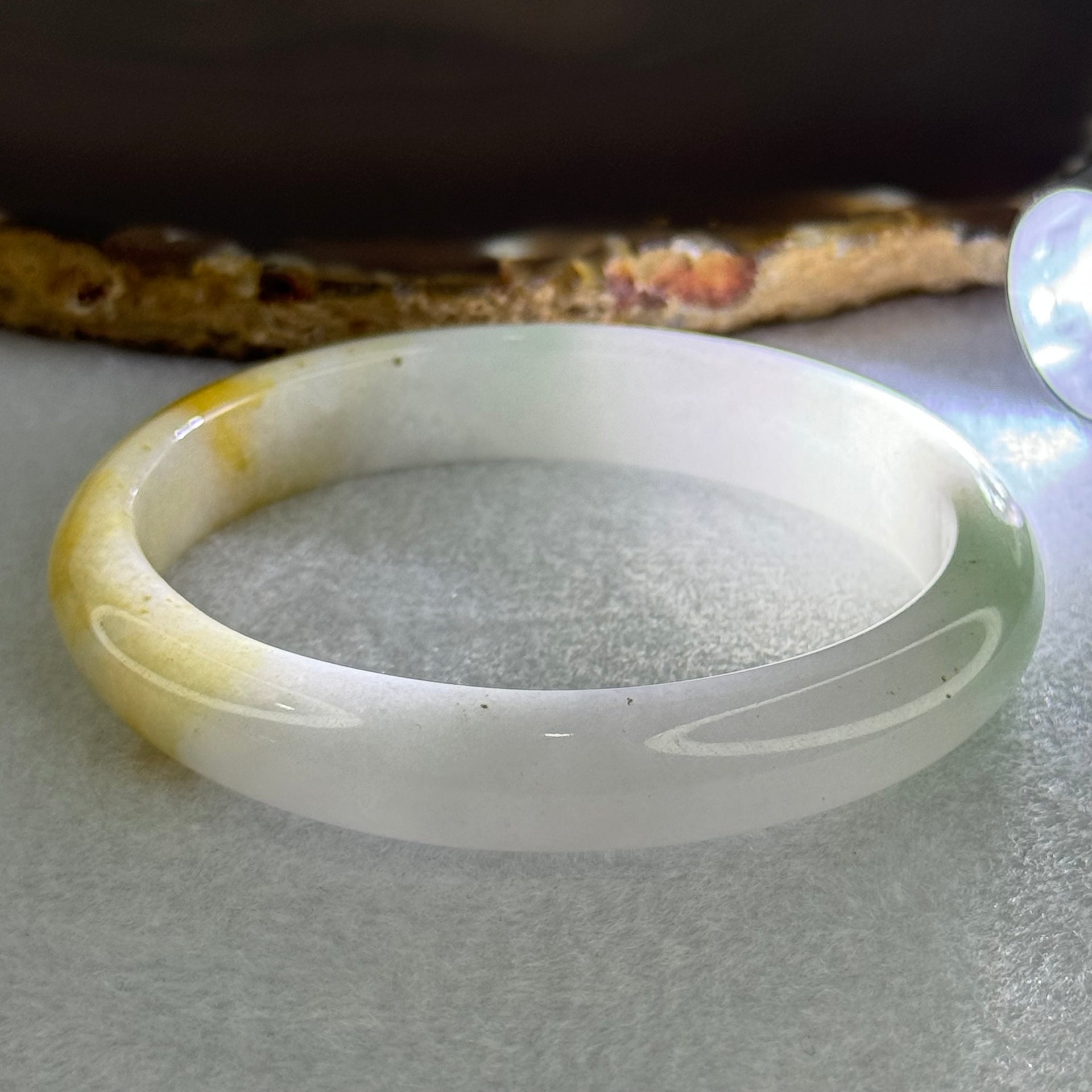 Type A Faint Lavender Green with Yellow Patches Jadeite Oval Bangle Internal Diameter 56.5mm  37.8696g 11.1 by 7.3mm (Very Slight Internal Line) - Huangs Jadeite and Jewelry Pte Ltd