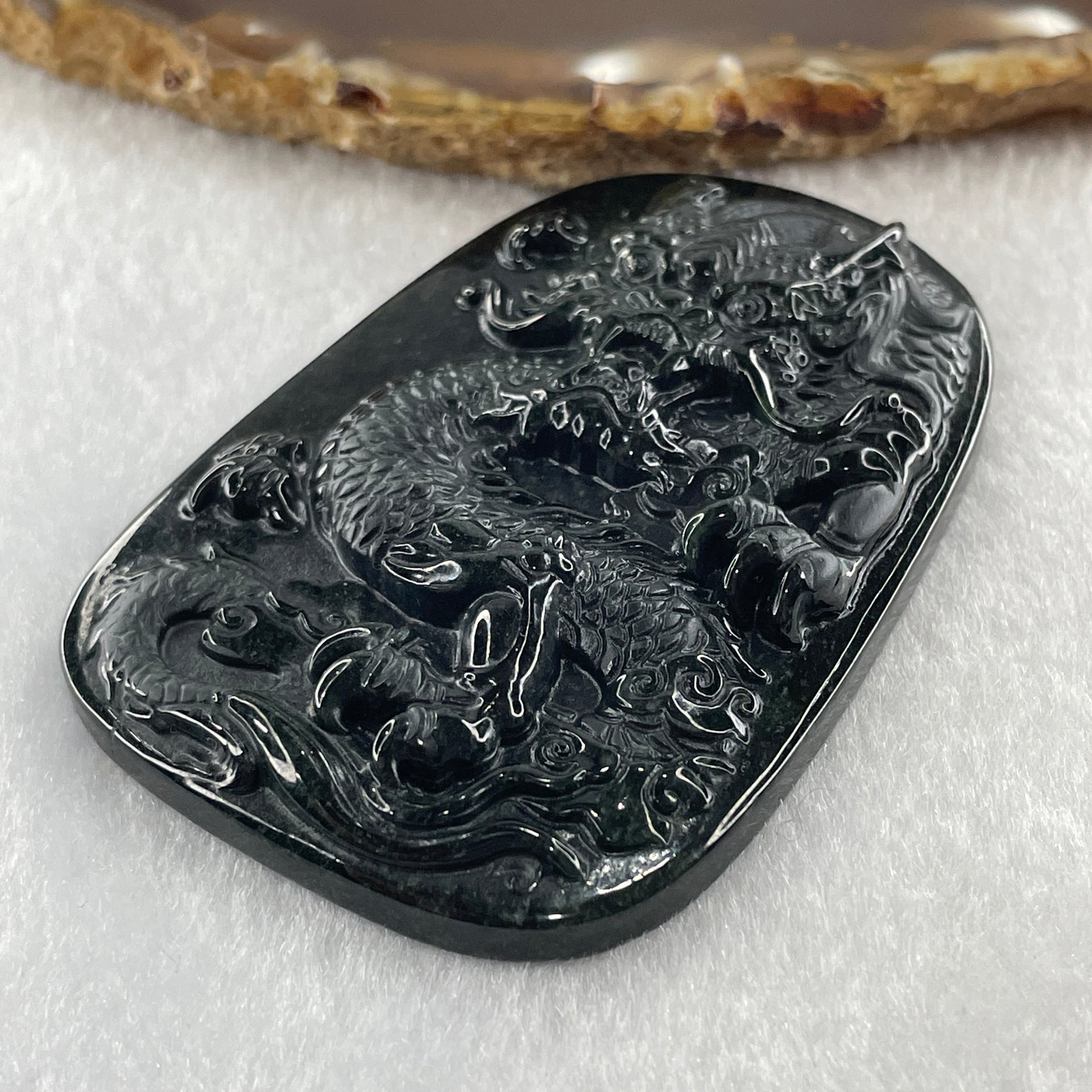 Type A Opaque to Partial Translucent Black Omphacite Jadeite Dragon Pendant 34.19g 66.8 by 45.5 by 9.4mm - Huangs Jadeite and Jewelry Pte Ltd
