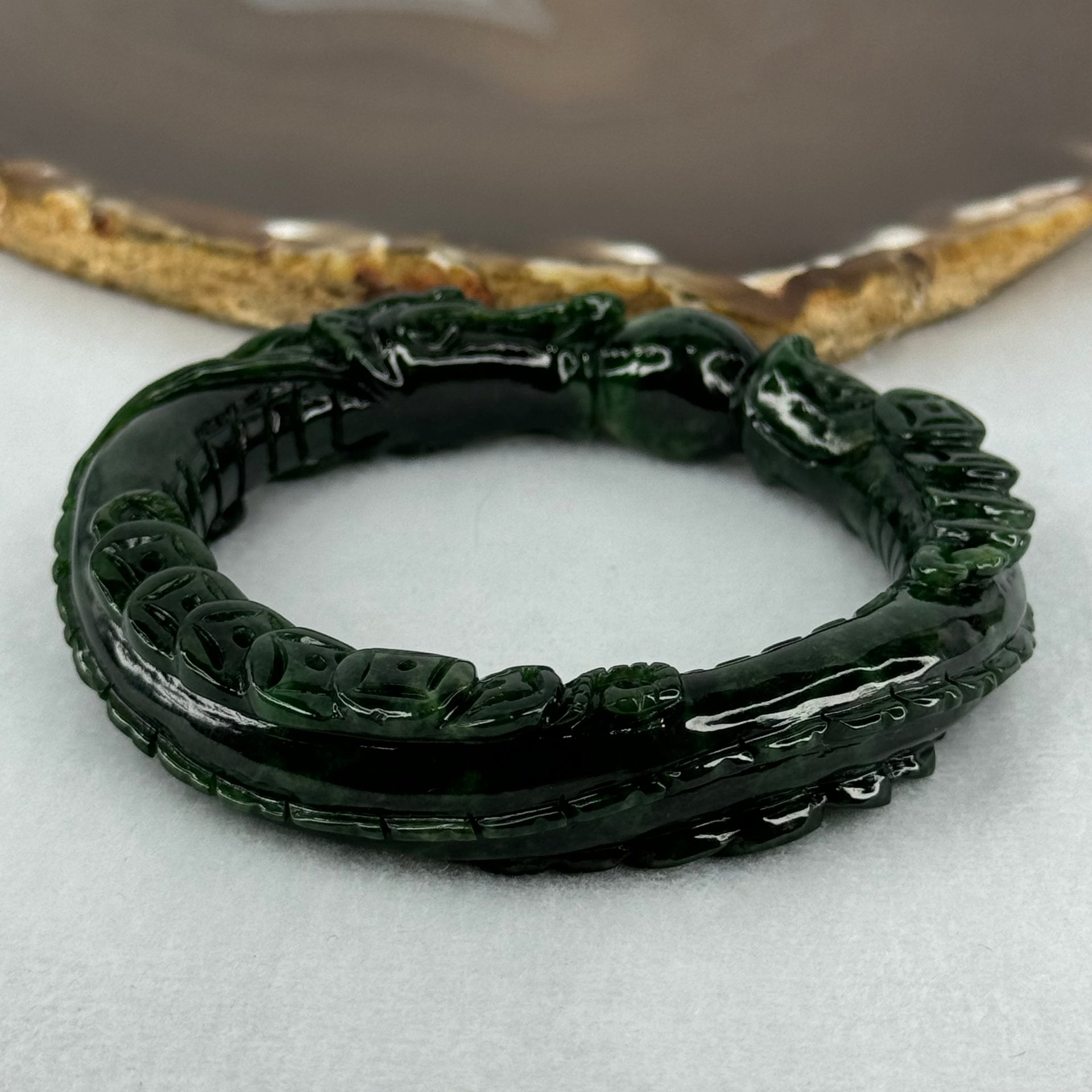 Type A Translucent to Opaque Old Mine Spicy Green Jadeite Dragon Bangle Internal Diameter 56.30mm 374.20cts 74.75g 16.0 by 12.5mm With NGI Cert 32885979 (Slight Internal Lines) - Huangs Jadeite and Jewelry Pte Ltd