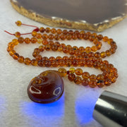 Natural Cognac Amber Ruyi Pendent 37.7 by 27.0 by 12.2mm in Amber Beads Necklace 6.3mm 105 Beads Total 19.80g - Huangs Jadeite and Jewelry Pte Ltd