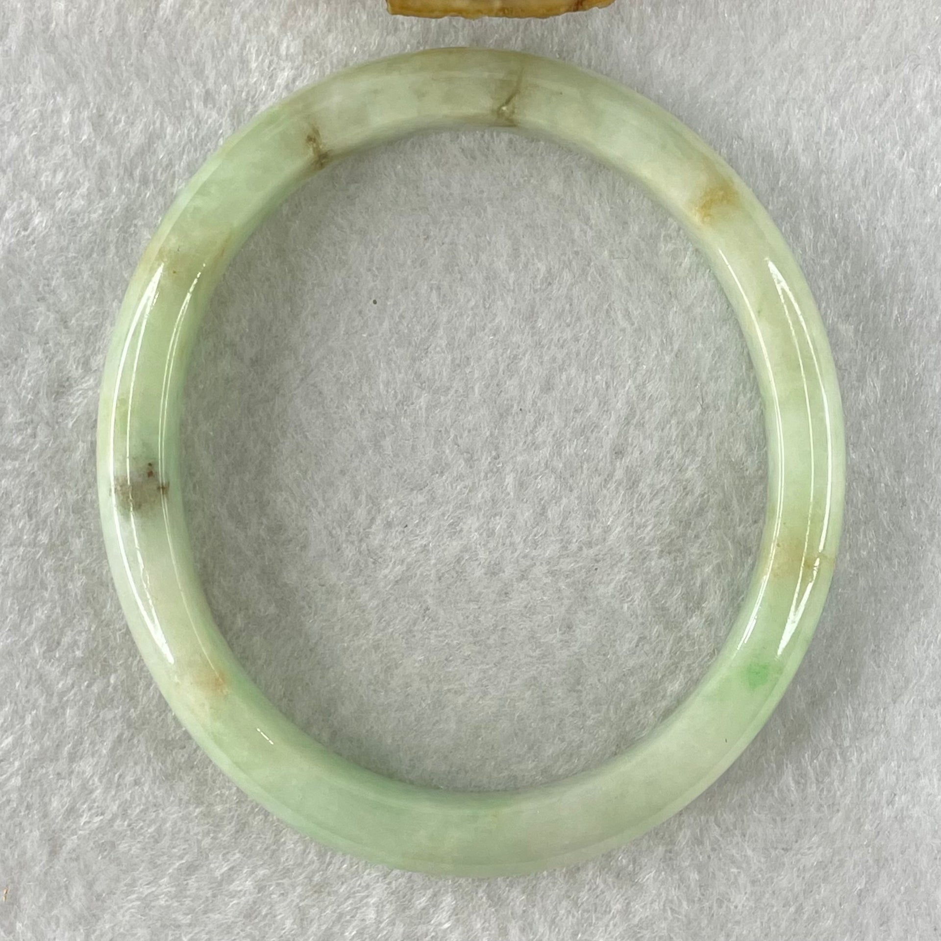 Type A Green with Brown Patches Jadeite Oval Bangle 31.51g Internal Diameter 55.6mm 10.3 by 6.6mm (External Roughs and Internal Lines) - Huangs Jadeite and Jewelry Pte Ltd