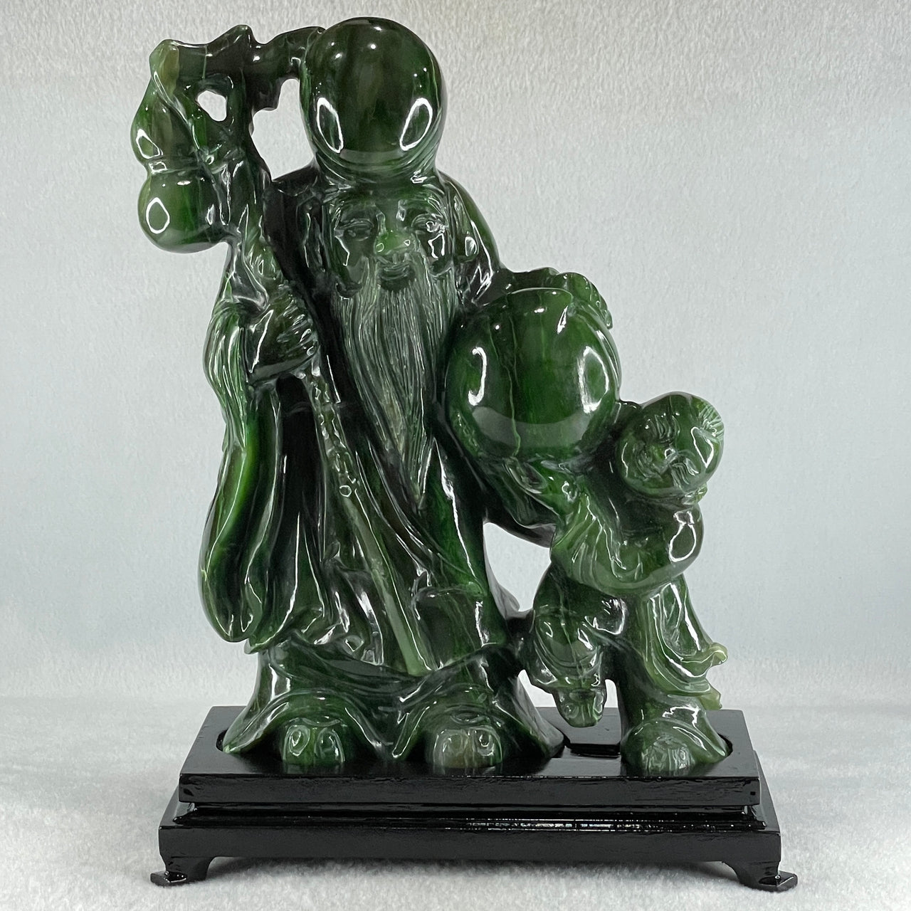 Natural Dark Green Serpentine Shou Xing Gong and Tong Zi and Longevity Peach with Wooden Stand Display 3,091.3g 193.0 by 95.0 by 257.0mm - Huangs Jadeite and Jewelry Pte Ltd