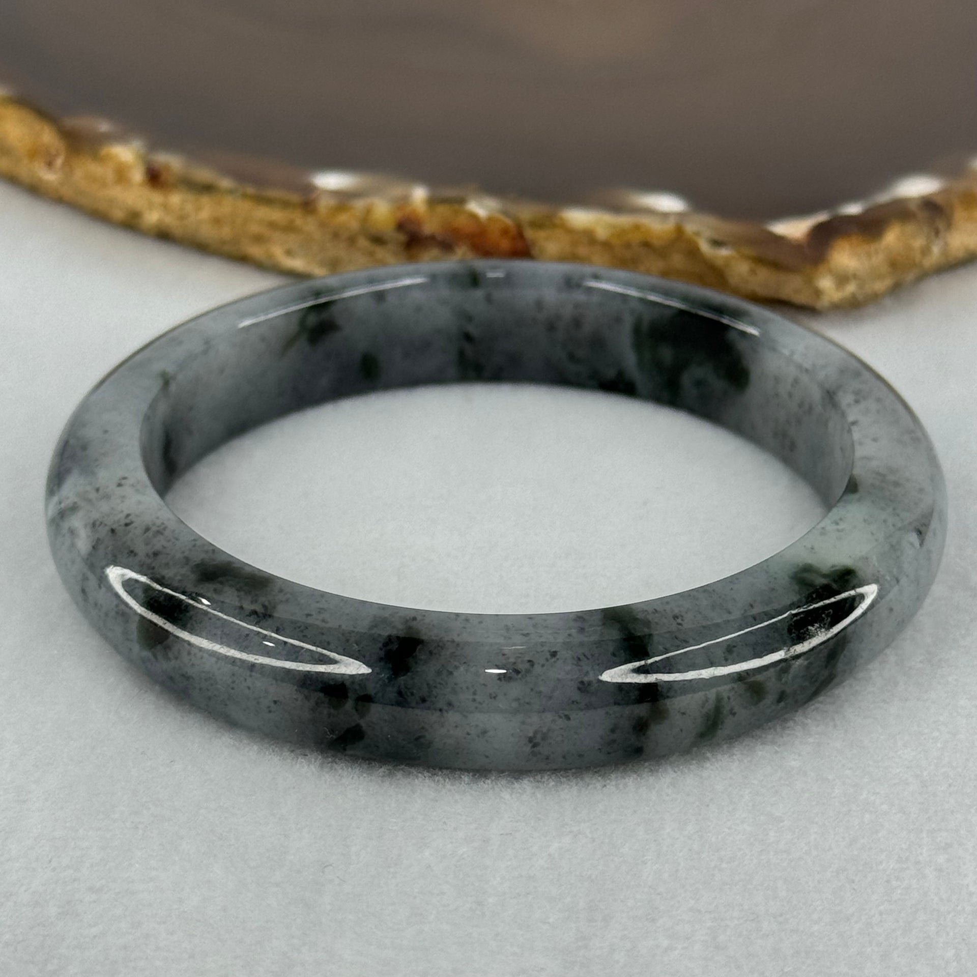 Type A Translucent Faint Grey with Greyish Black Patches Jadeite Bangle Internal Diameter 58.55mm 289.81cts 58.40g 11.8 by 8.6mm With NGI Cert 32885981 (Very Slight Internal Lines) - Huangs Jadeite and Jewelry Pte Ltd