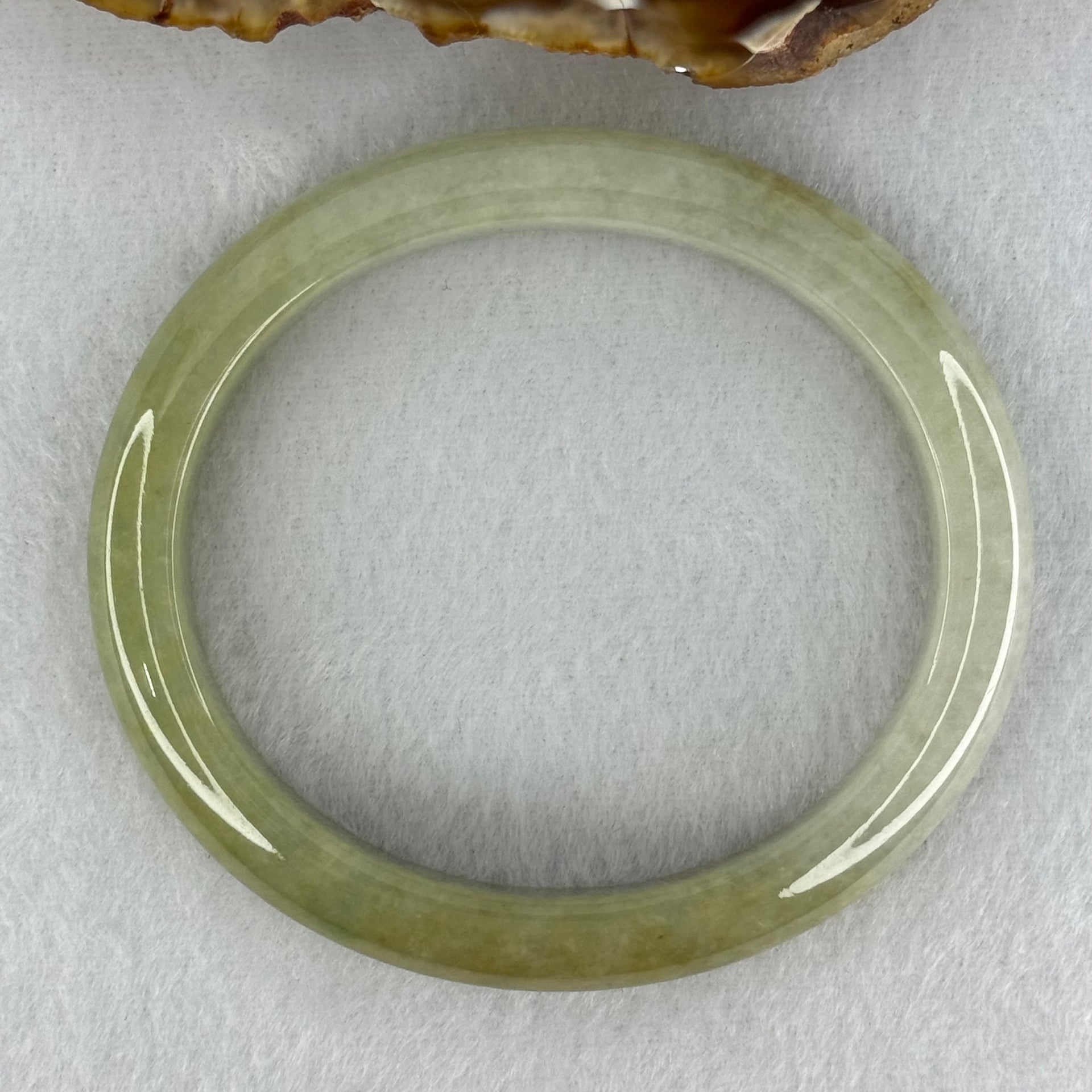Type A Yellowish Green Lavender Jadeite Oval Bangle Internal Diameter 58.5mm 67.31g 10.7 by 8.1mm (Very Slight Fine Internal Line) - Huangs Jadeite and Jewelry Pte Ltd