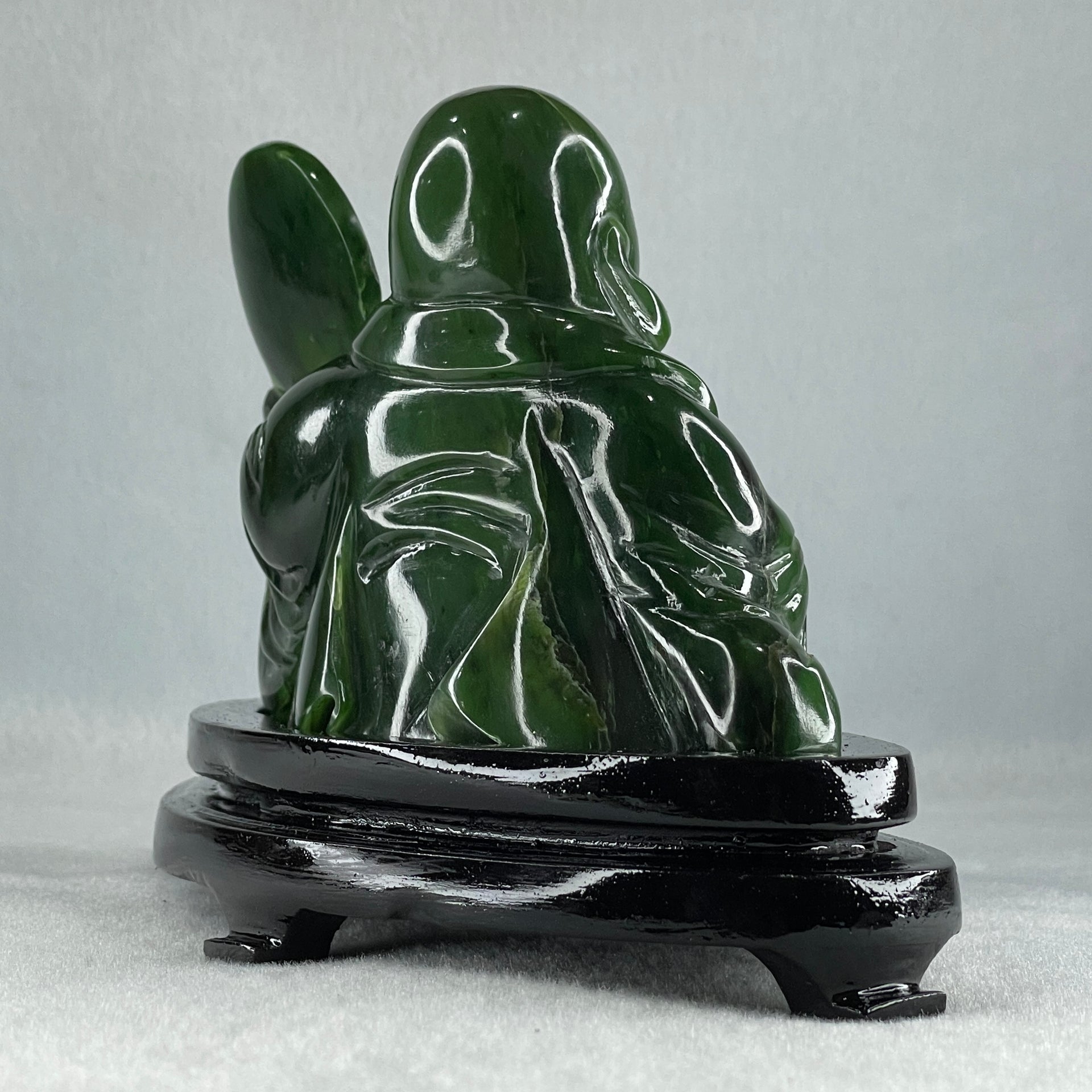 Natural Dark Green Serpentine Siting Milo Buddha with Waving Fan with Wooden Stand Display 765.0g 180.0 by 90.0 by 115.0mm - Huangs Jadeite and Jewelry Pte Ltd