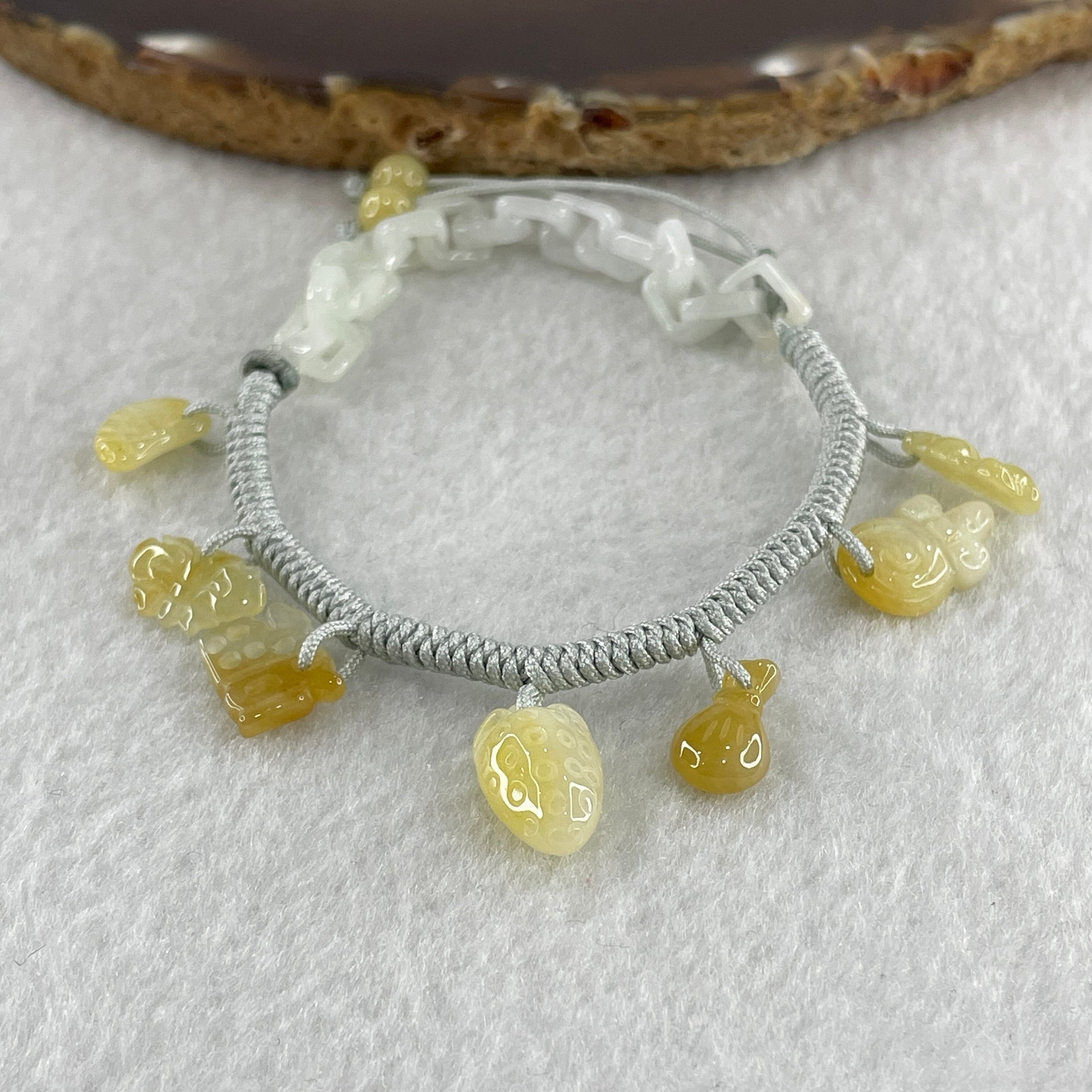 Natural Type A Yellowish Jadeite Money Bag Hulu Fu Butterfly in String Bracelet 8.79g 16-20cm 12.7 by 8.8 by 6.9mm - Huangs Jadeite and Jewelry Pte Ltd