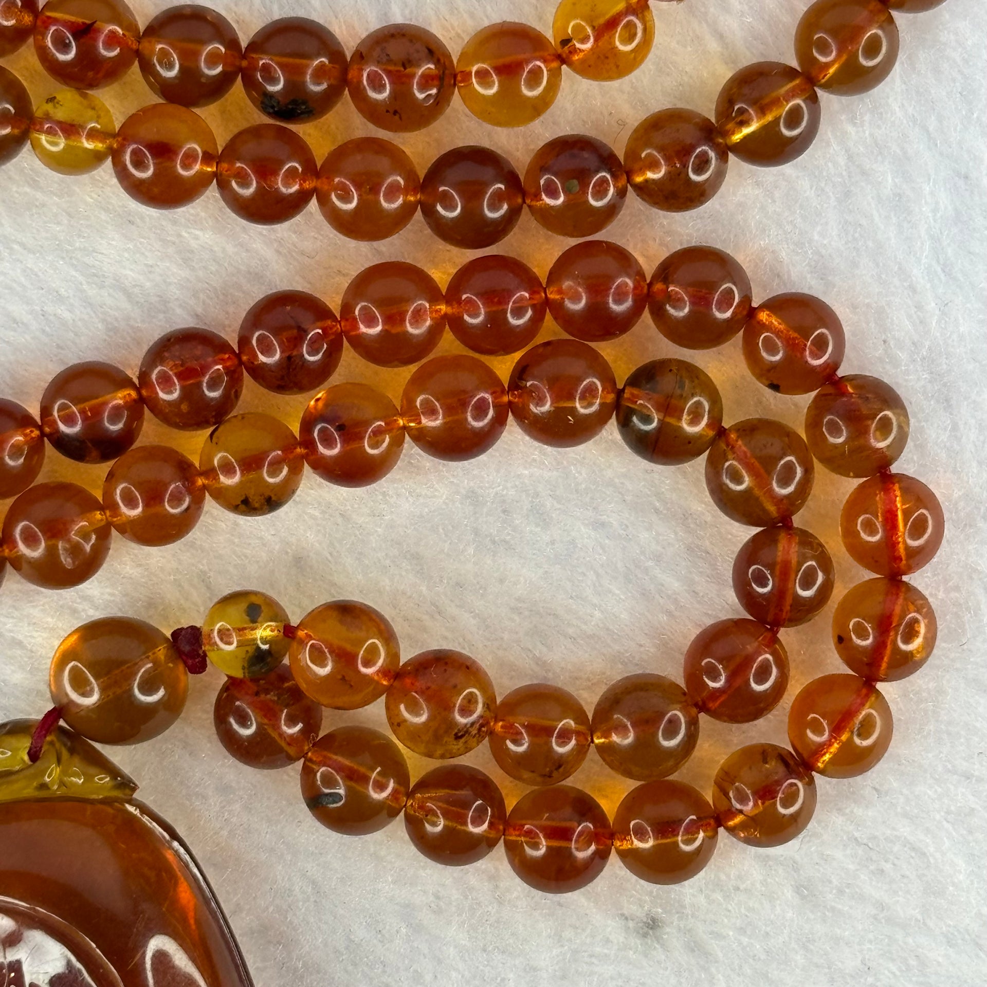 Natural Cognac Amber Ruyi Pendent 37.7 by 27.0 by 12.2mm in Amber Beads Necklace 6.3mm 105 Beads Total 19.80g - Huangs Jadeite and Jewelry Pte Ltd