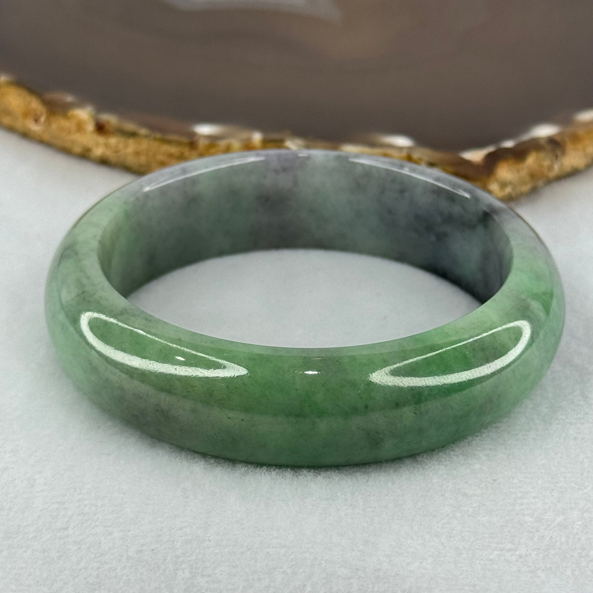 Type A Translucent Light Green with Patches of Faint Grey and Greyish Black Jadeite Bangle Internal Diameter 57.75mm 404.45cts 81.28g 17.3 by 9.0mm With NGI Cert No 32885808 (Very Slight Internal Lines) - Huangs Jadeite and Jewelry Pte Ltd