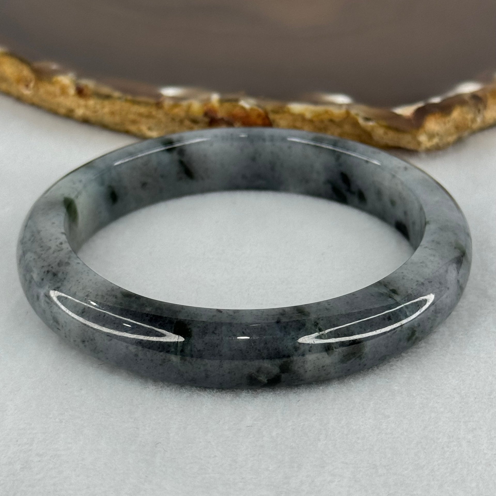 Type A Translucent Faint Grey with Greyish Black Patches Jadeite Bangle Internal Diameter 58.55mm 289.81cts 58.40g 11.8 by 8.6mm With NGI Cert 32885981 (Very Slight Internal Lines) - Huangs Jadeite and Jewelry Pte Ltd