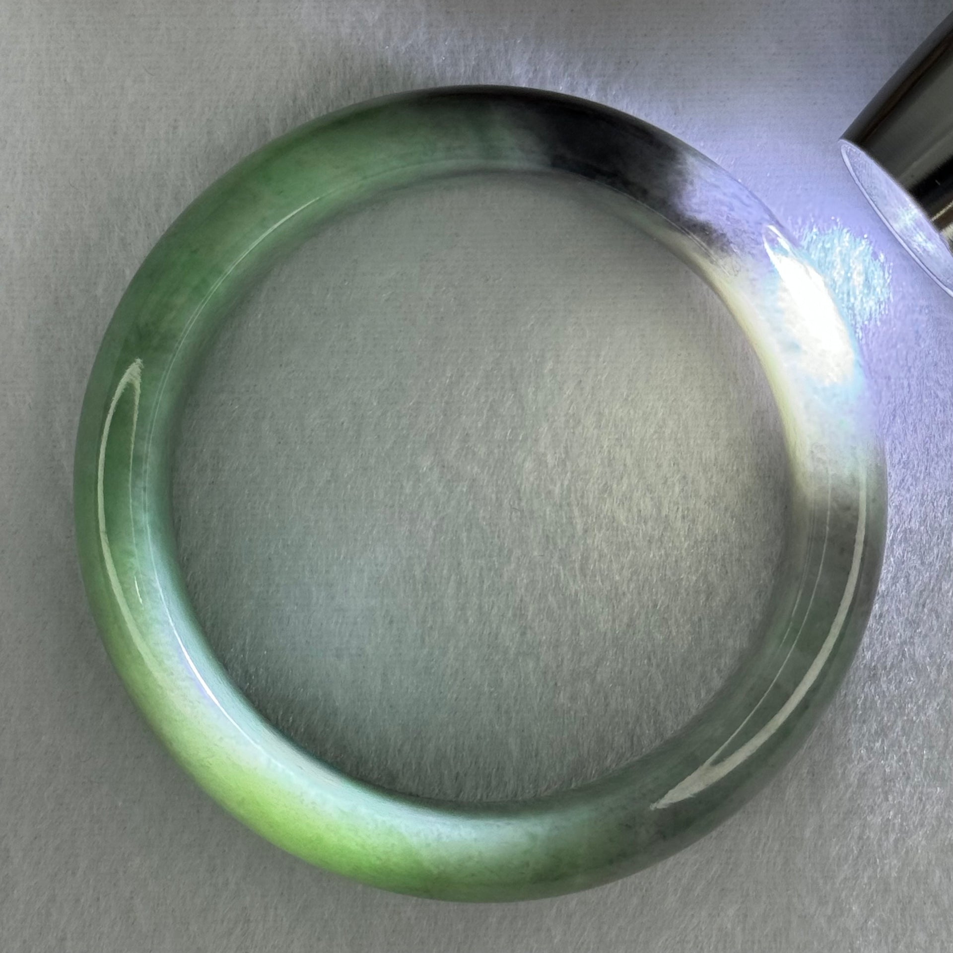 Type A Translucent Light Green with Patches of Faint Grey and Greyish Black Jadeite Bangle Internal Diameter 57.75mm 404.45cts 81.28g 17.3 by 9.0mm With NGI Cert No 32885808 (Very Slight Internal Lines) - Huangs Jadeite and Jewelry Pte Ltd