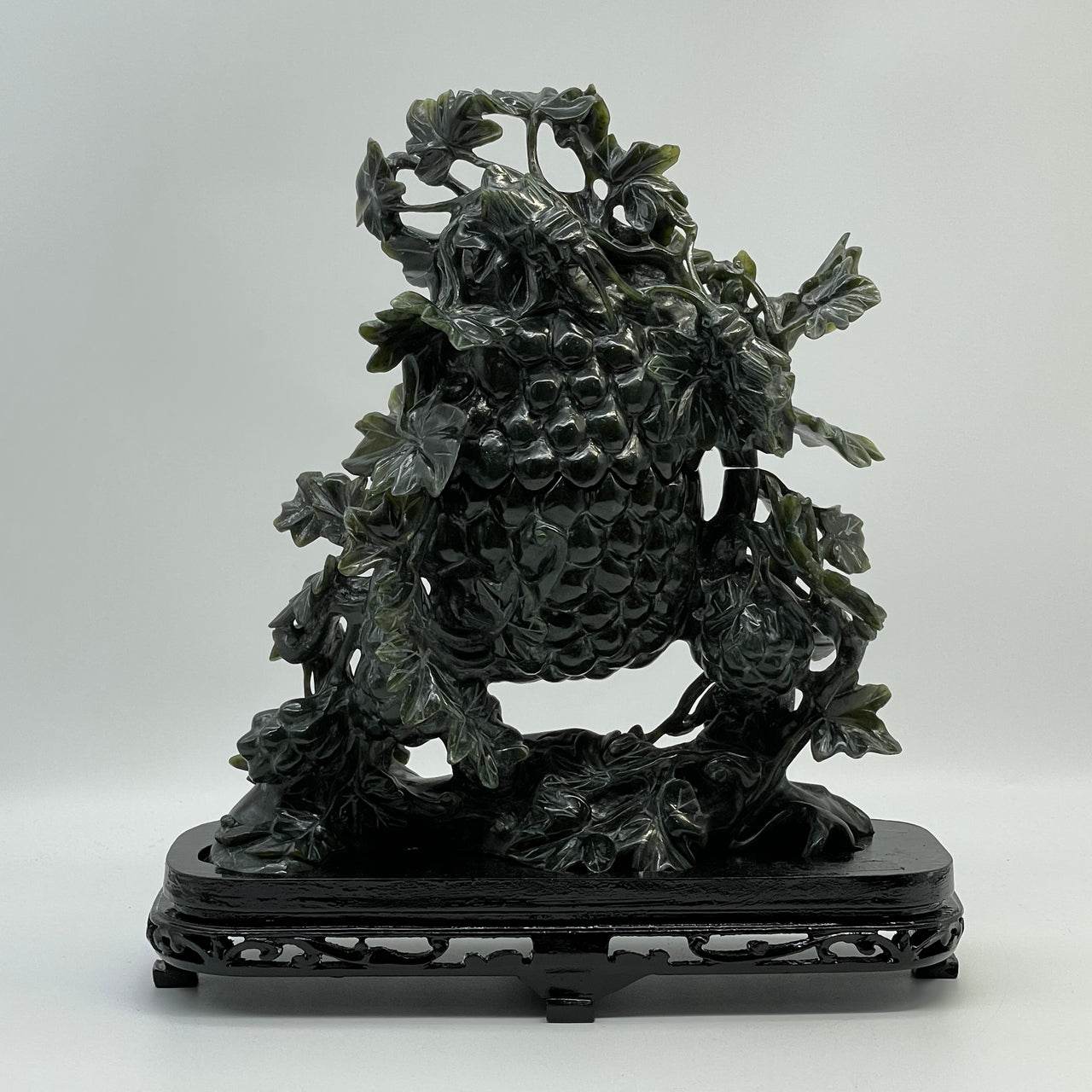 Dark green nephrite jade crickets on grapevine carving with wooden display stand