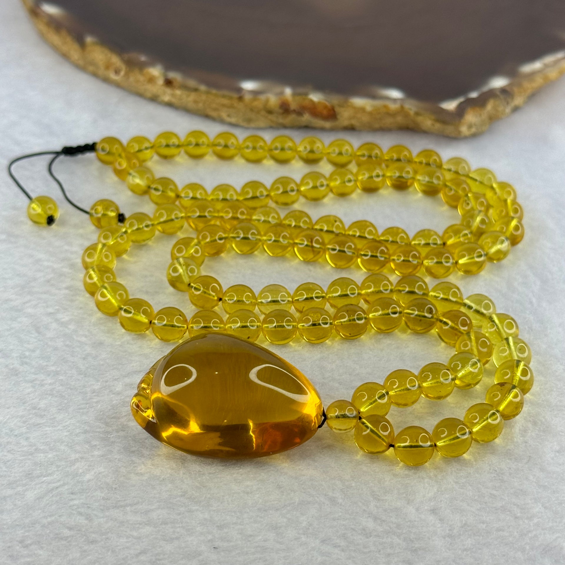 Natural Yellow Amber Foot Pendent 32.5 by 24.2 by 19.5mm with Yellow Amber Beads Necklace 6.9mm 104 Beads Total 22.56g - Huangs Jadeite and Jewelry Pte Ltd