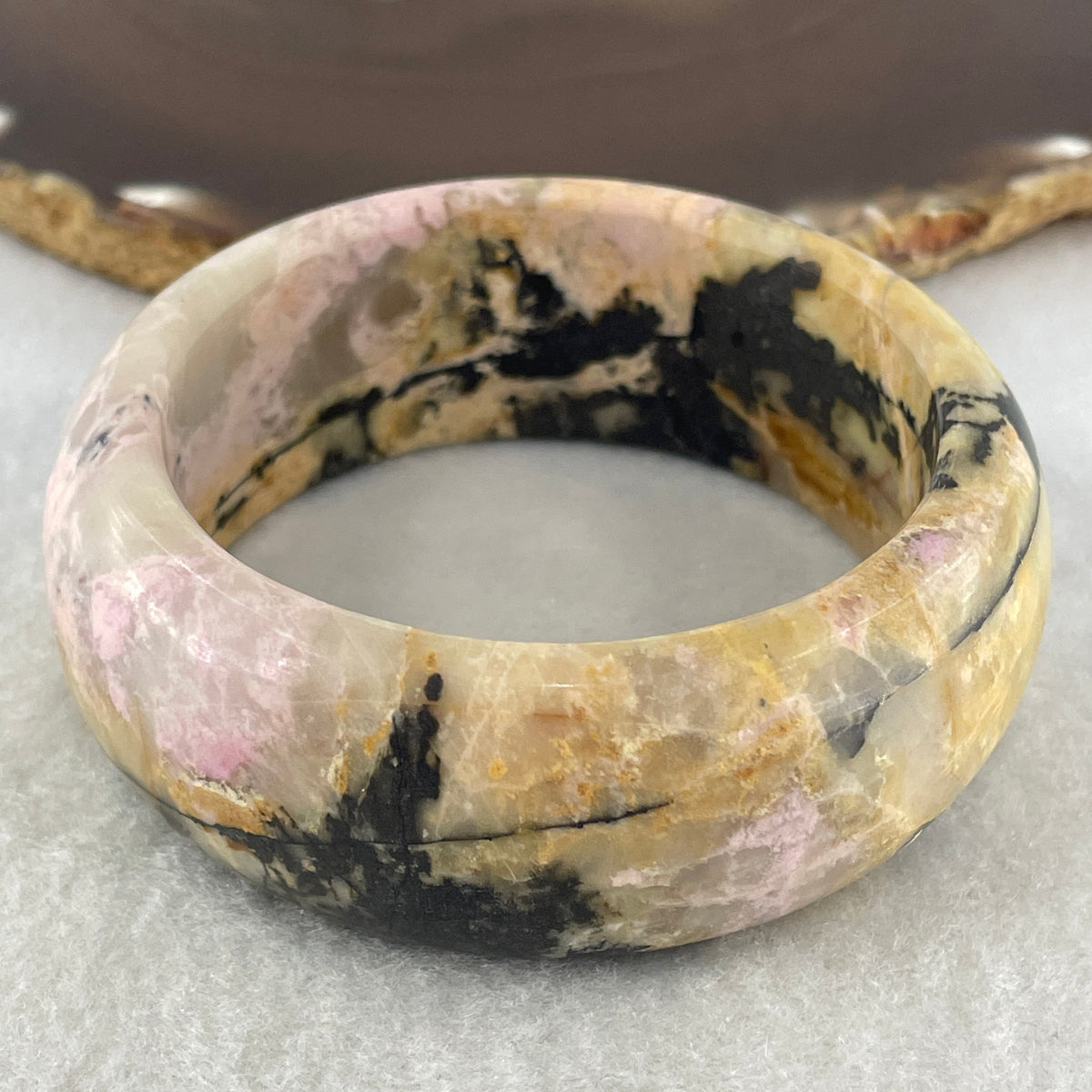 Entry Grade Natural Yellow with Black Rhodonite Bangle 105.93g Inner Diameter 55.2mm 25.5 by 11.7mm - Huangs Jadeite and Jewelry Pte Ltd