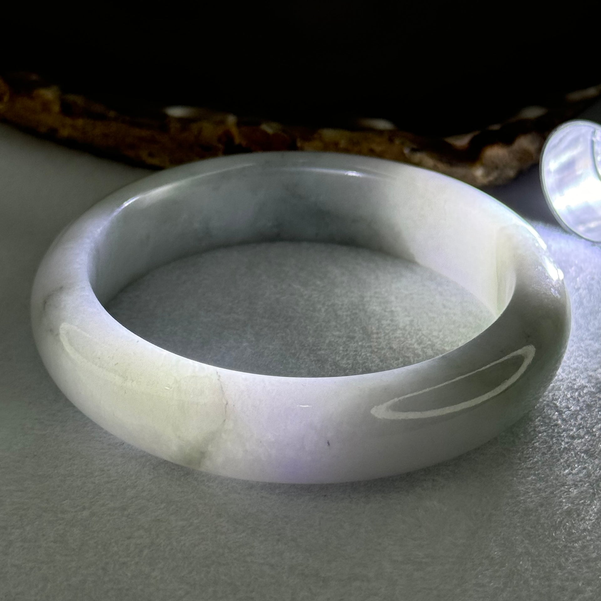Type A Translucent Faint Blueish Green with Patches of Light Grey and Faint Lavender Jadeite Bangle Internal Diameter 56.95mm 344.09cts 69.22g 14.6 by 8.9mm With NGI Cert No 32886054 (Very Slight Internal Line) - Huangs Jadeite and Jewelry Pte Ltd