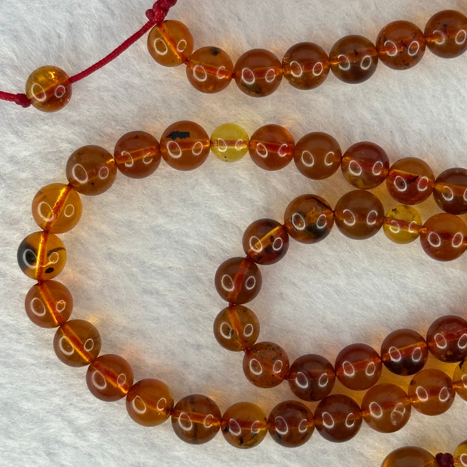 Natural Cognac Amber Ruyi Pendent 37.7 by 27.0 by 12.2mm in Amber Beads Necklace 6.3mm 105 Beads Total 19.80g - Huangs Jadeite and Jewelry Pte Ltd