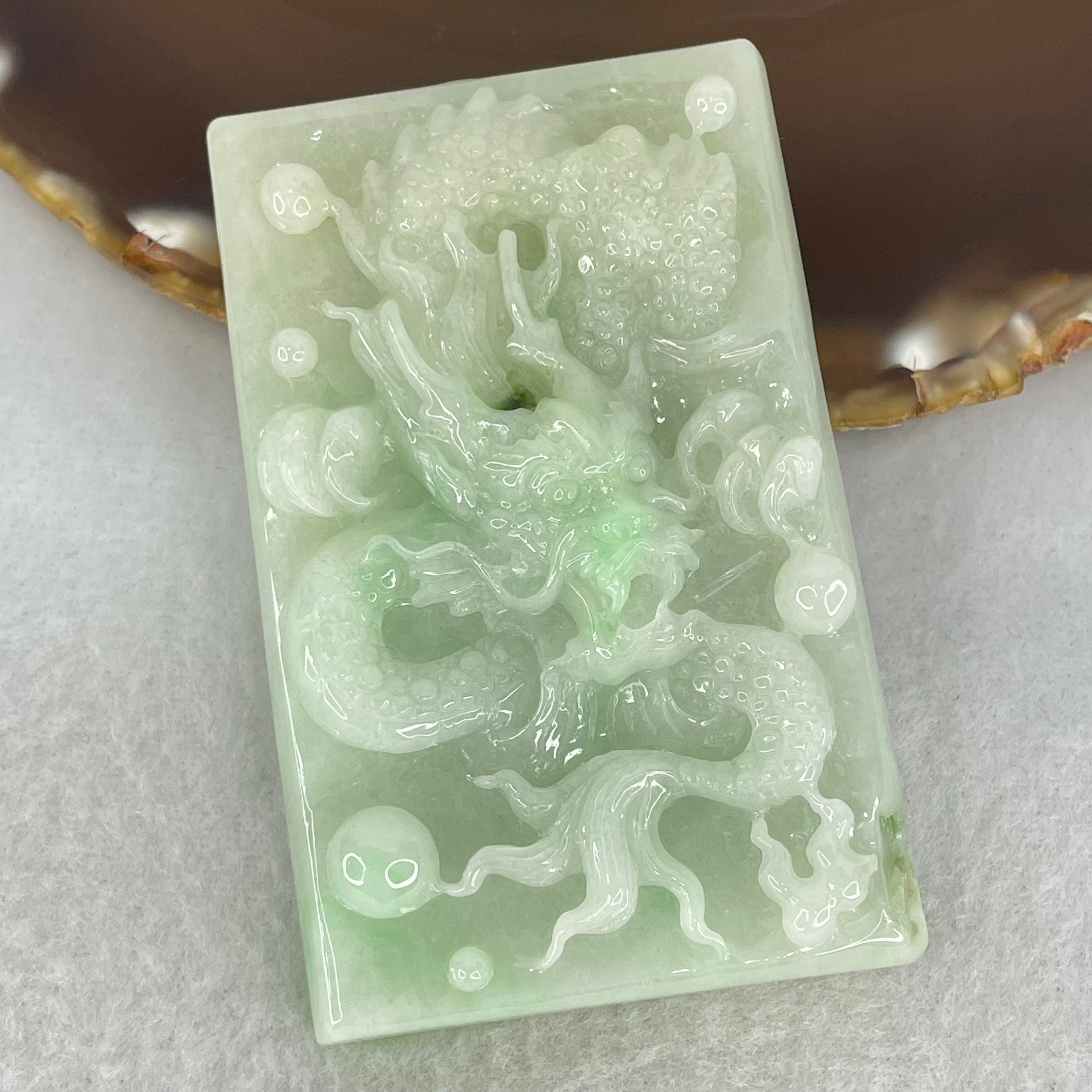 Type A Light Apple Green Jadeite Dragon Pendant 87.90g 69.4 by 44.2 by 14.2mm - Huangs Jadeite and Jewelry Pte Ltd