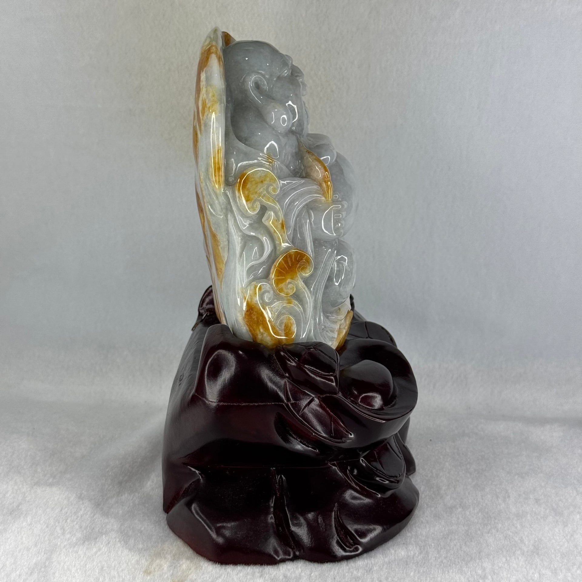 Type A Light Green with Faint Lavender and Yellow Jadeite Milo Buddha Display 170.0 by 100.0 by 190.0mm with wooden stand 2,574.1g - Huangs Jadeite and Jewelry Pte Ltd