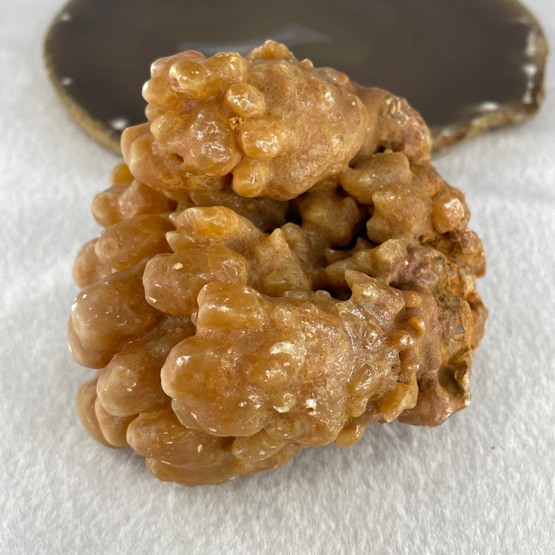 Natural Orange Calcite Rough Display with Wooden Stand 540.6g 109.7 by 94.1 by 123.0mm - Huangs Jadeite and Jewelry Pte Ltd