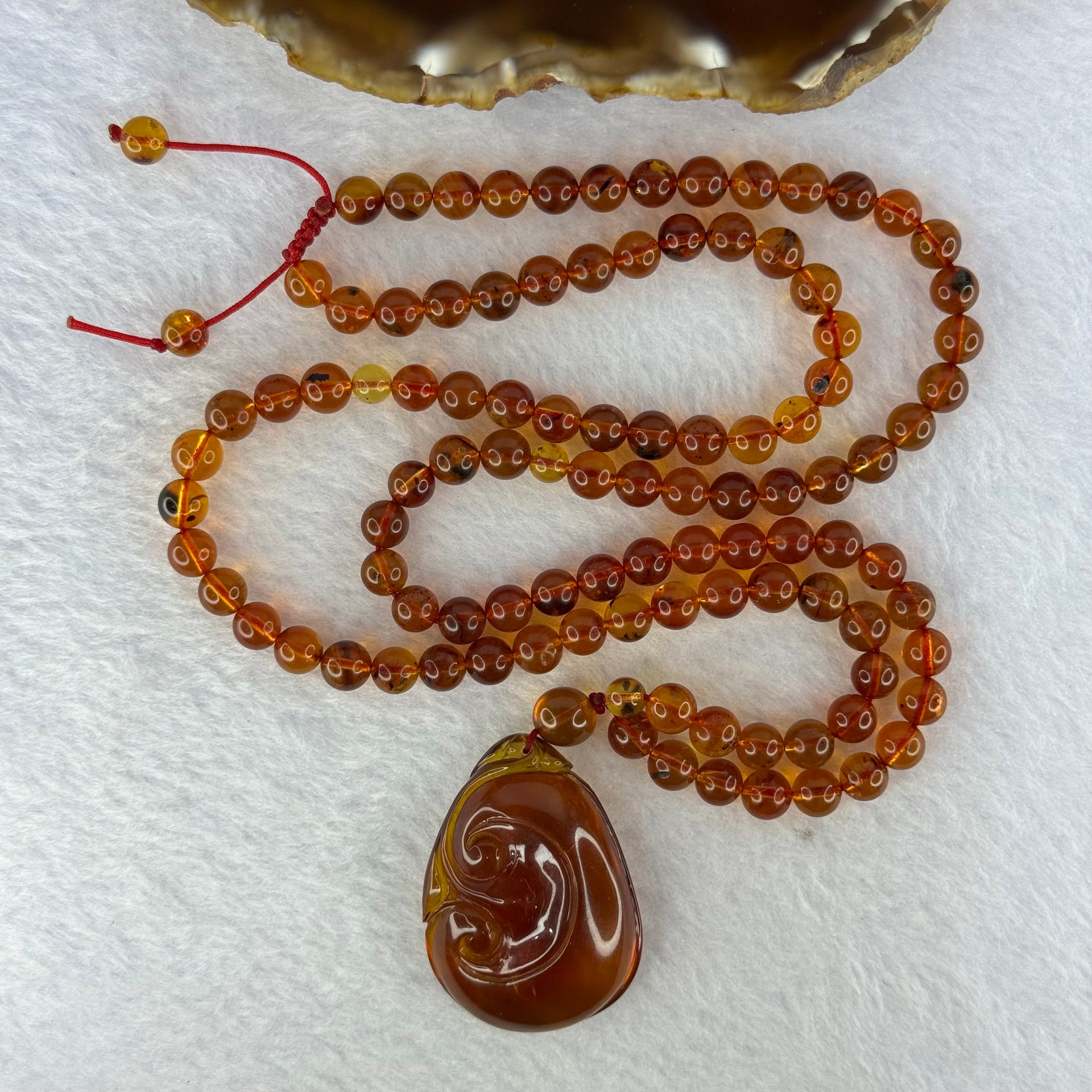 Natural Cognac Amber Ruyi Pendent 37.7 by 27.0 by 12.2mm in Amber Beads Necklace 6.3mm 105 Beads Total 19.80g - Huangs Jadeite and Jewelry Pte Ltd