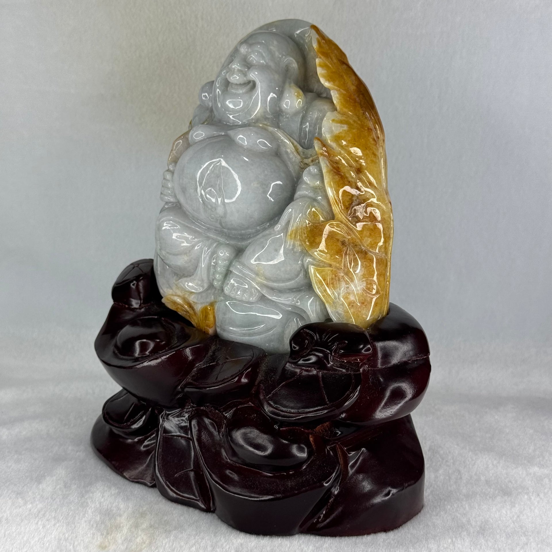 Type A Light Green with Faint Lavender and Yellow Jadeite Milo Buddha Display 170.0 by 100.0 by 190.0mm with wooden stand 2,574.1g - Huangs Jadeite and Jewelry Pte Ltd