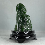 Natural Dark Green Serpentine Siting Milo Buddha with Waving Fan with Wooden Stand Display 765.0g 180.0 by 90.0 by 115.0mm - Huangs Jadeite and Jewelry Pte Ltd