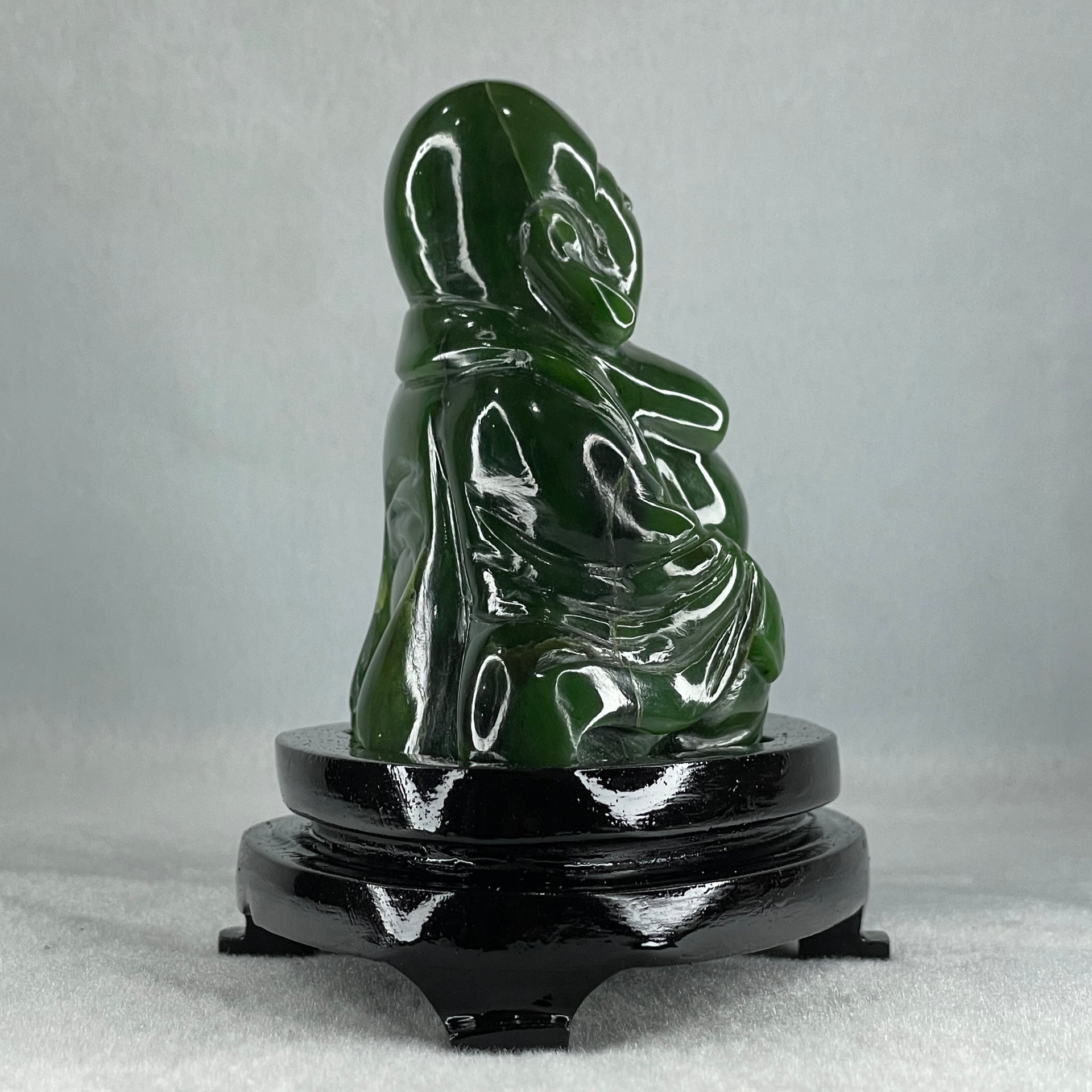 Natural Dark Green Serpentine Siting Milo Buddha with Waving Fan with Wooden Stand Display 765.0g 180.0 by 90.0 by 115.0mm - Huangs Jadeite and Jewelry Pte Ltd