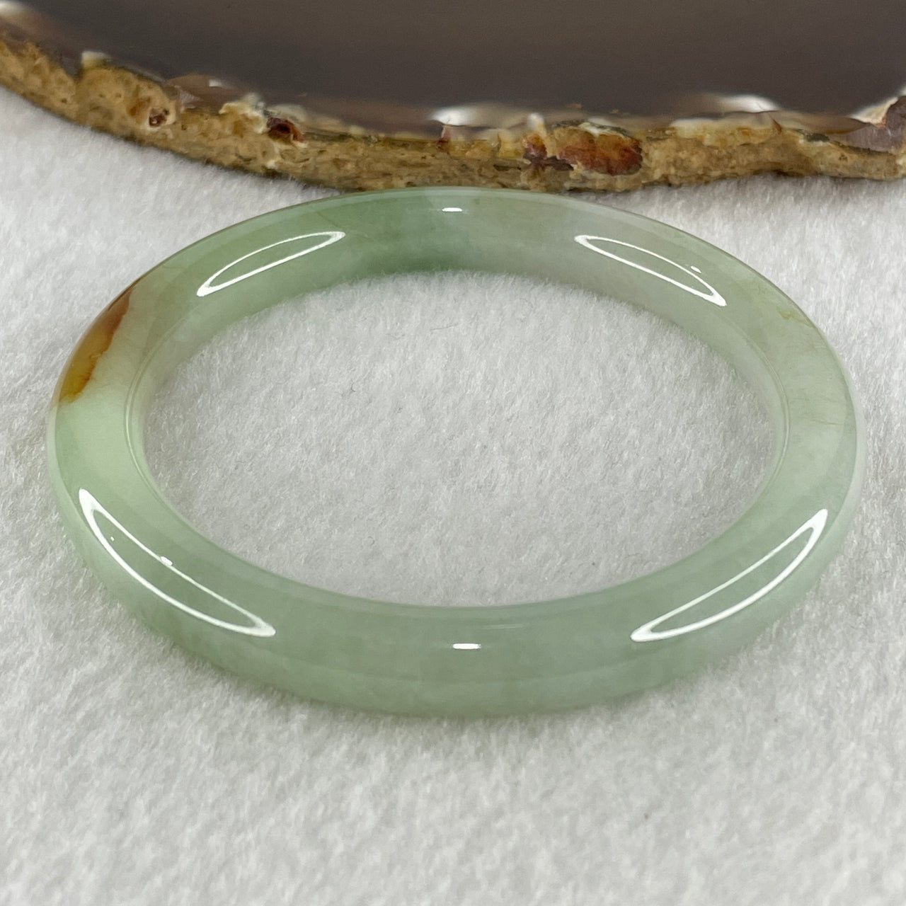 Natural Type A Light Green with Yellow Brown Patch Jadeite Bangle 38.72g Inner Diameter 56.5mm Thickness 8.7 by 8.6mm (Internal Lines)