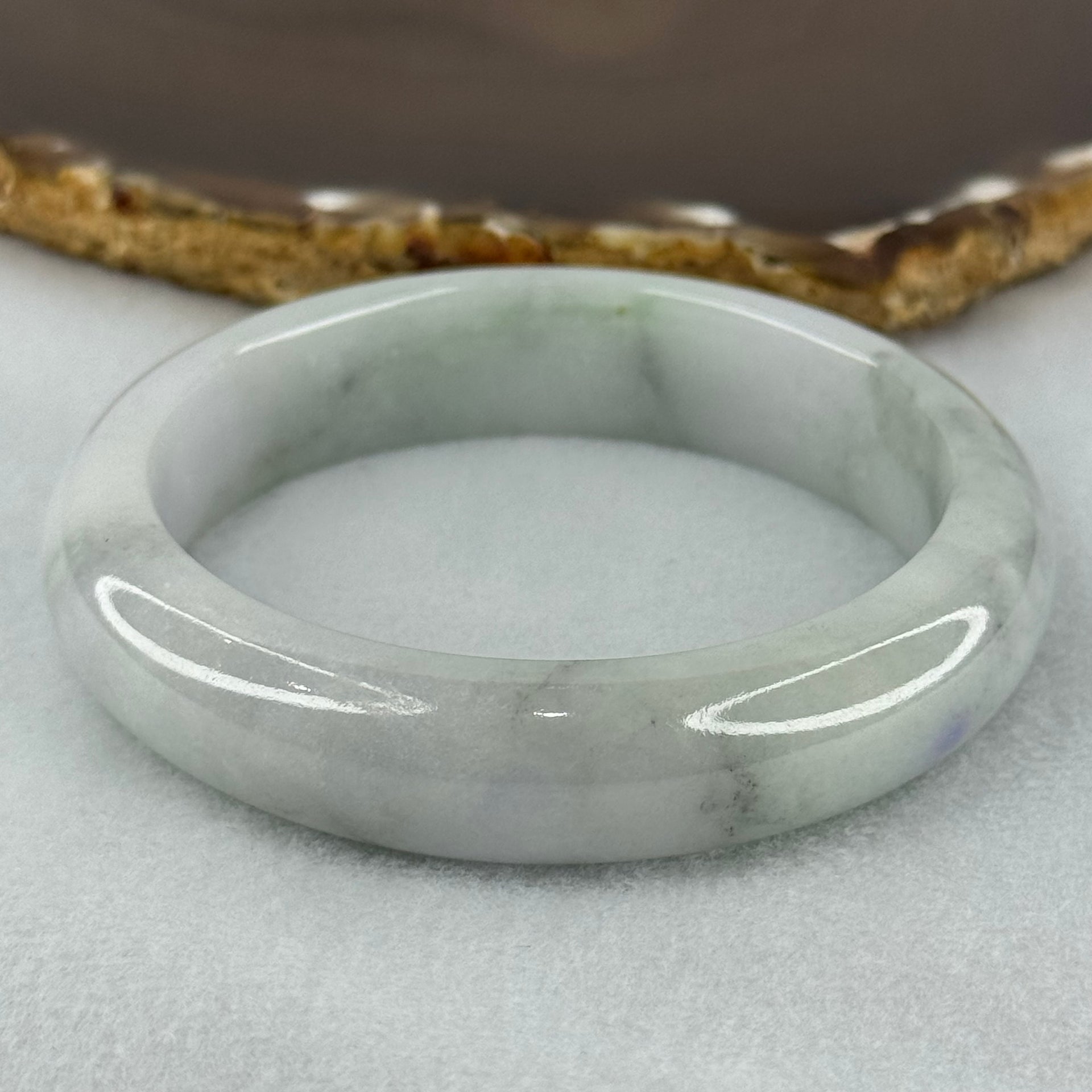 Type A Translucent Faint Blueish Green with Patches of Light Grey and Faint Lavender Jadeite Bangle Internal Diameter 56.95mm 344.09cts 69.22g 14.6 by 8.9mm With NGI Cert No 32886054 (Very Slight Internal Line) - Huangs Jadeite and Jewelry Pte Ltd