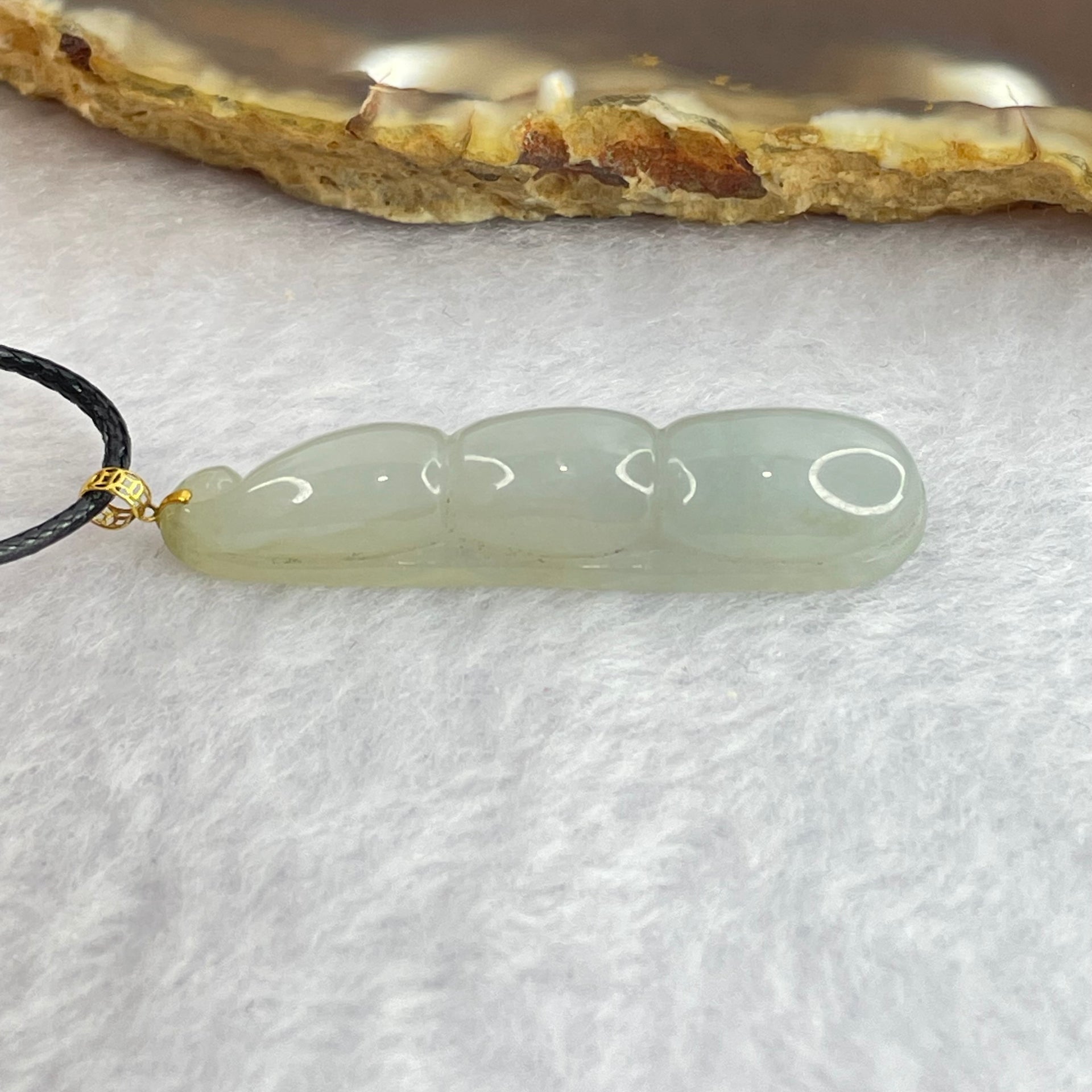 Type A Faint Green Jadeite Peapod Pendent 6.17g 39.1 by 11.3 by 7.1mm - Huangs Jadeite and Jewelry Pte Ltd