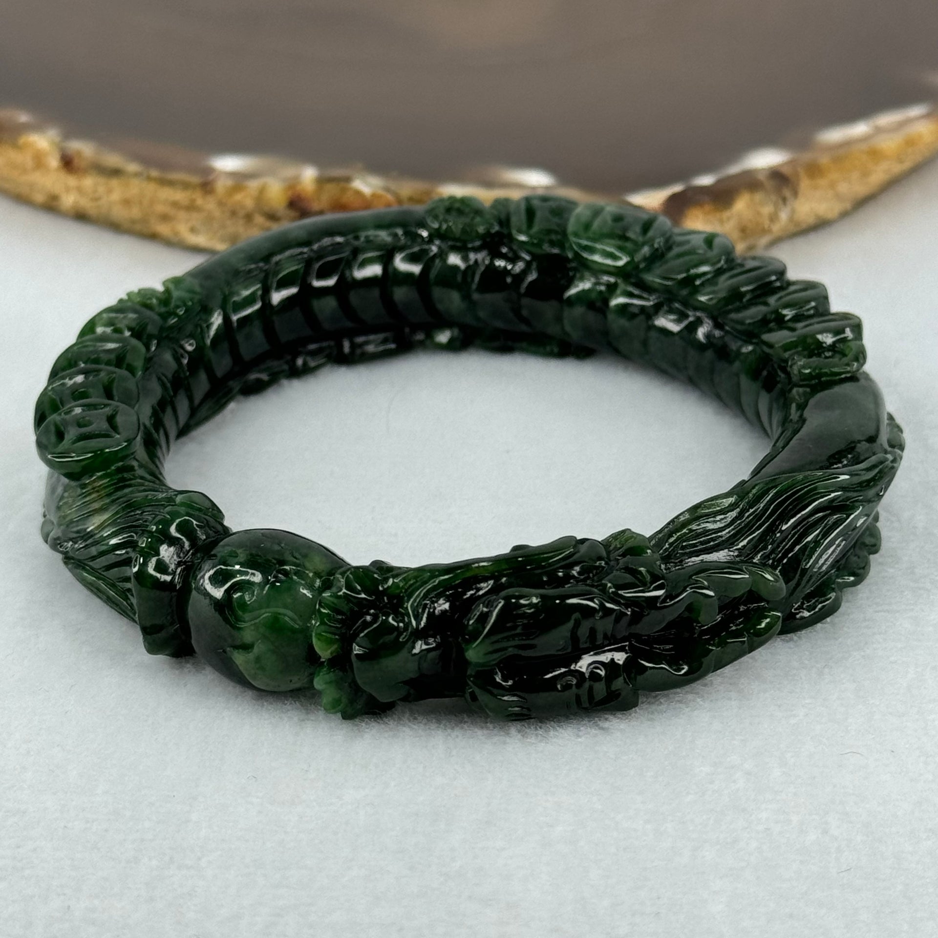 Type A Translucent to Opaque Old Mine Spicy Green Jadeite Dragon Bangle Internal Diameter 56.30mm 374.20cts 74.75g 16.0 by 12.5mm With NGI Cert 32885979 (Slight Internal Lines) - Huangs Jadeite and Jewelry Pte Ltd