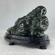 Natural Dark Green Serpentine Laughing Milo Buddha with Wealth Pot with Wooden Stand Display 1,656.6g 190.0 by 133.0 by 127.0mm - Huangs Jadeite and Jewelry Pte Ltd