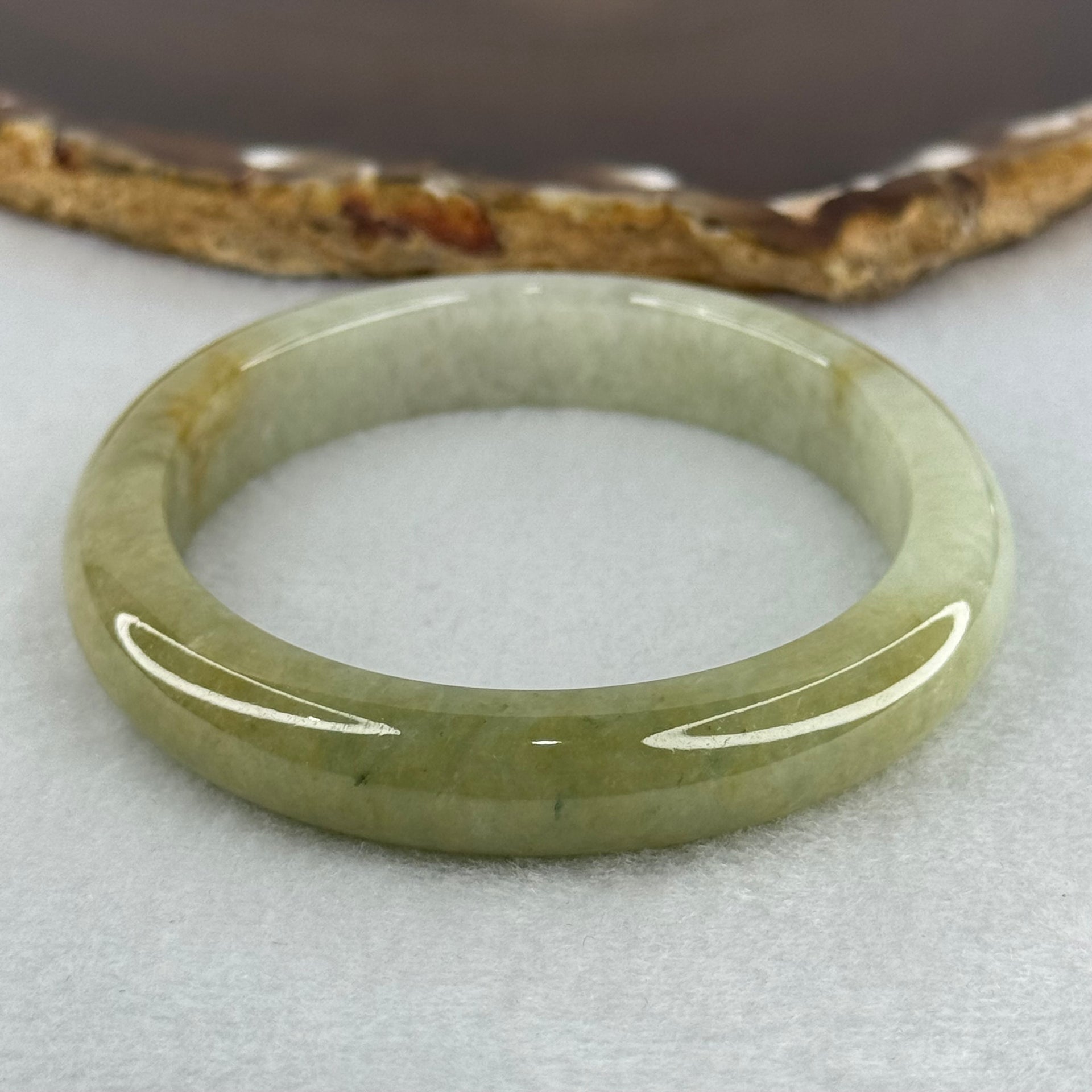 Type A Yellowish Green Lavender Jadeite Oval Bangle Internal Diameter 58.5mm 67.31g 10.7 by 8.1mm (Very Slight Fine Internal Line) - Huangs Jadeite and Jewelry Pte Ltd