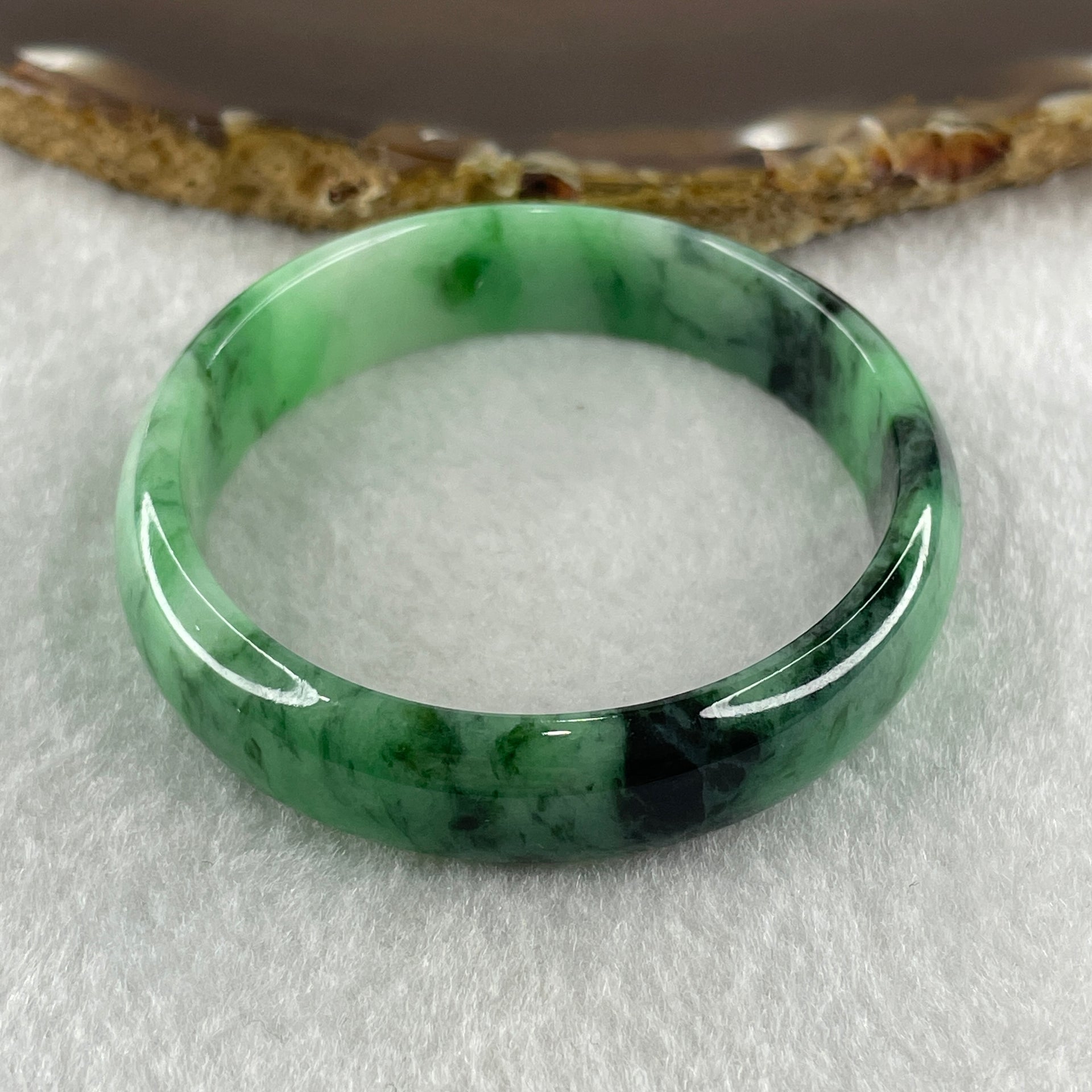 Type A Natural Old Mine Spicy Green with Dark Green Piao Hua Flora Jadeite Oval Bangle 26.28g 131.60cts Inner Diameter 52.55mm 46.90 by 5.40mm with NGI Cert 63804952 (Very Very Slight Internal Lines) - Huangs Jadeite and Jewelry Pte Ltd
