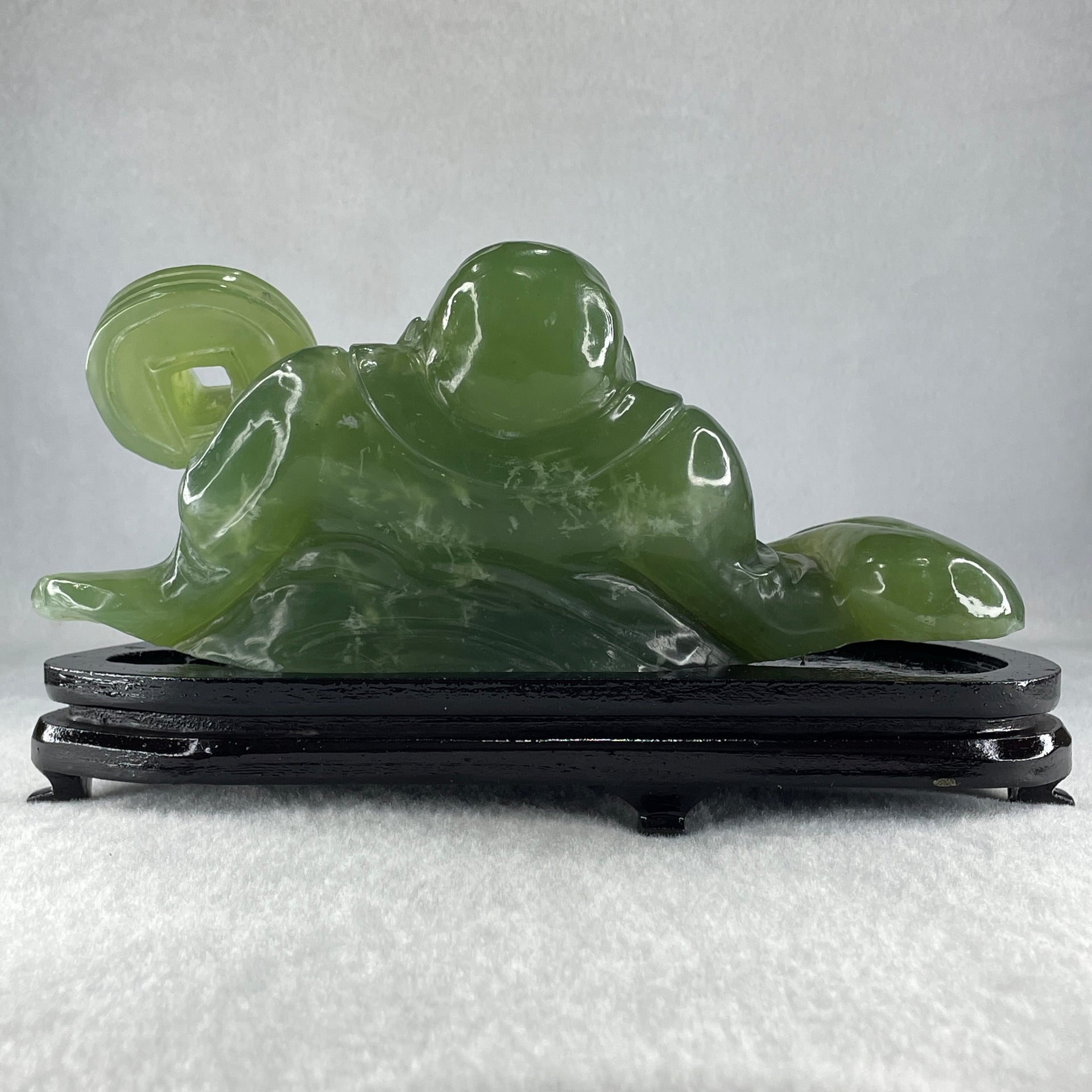 Natural Green Serpentine Siting Milo Buddha with Coin with Wooden Stand Display 1014.8g 200.0 by 100.0 by 105.0mm - Huangs Jadeite and Jewelry Pte Ltd